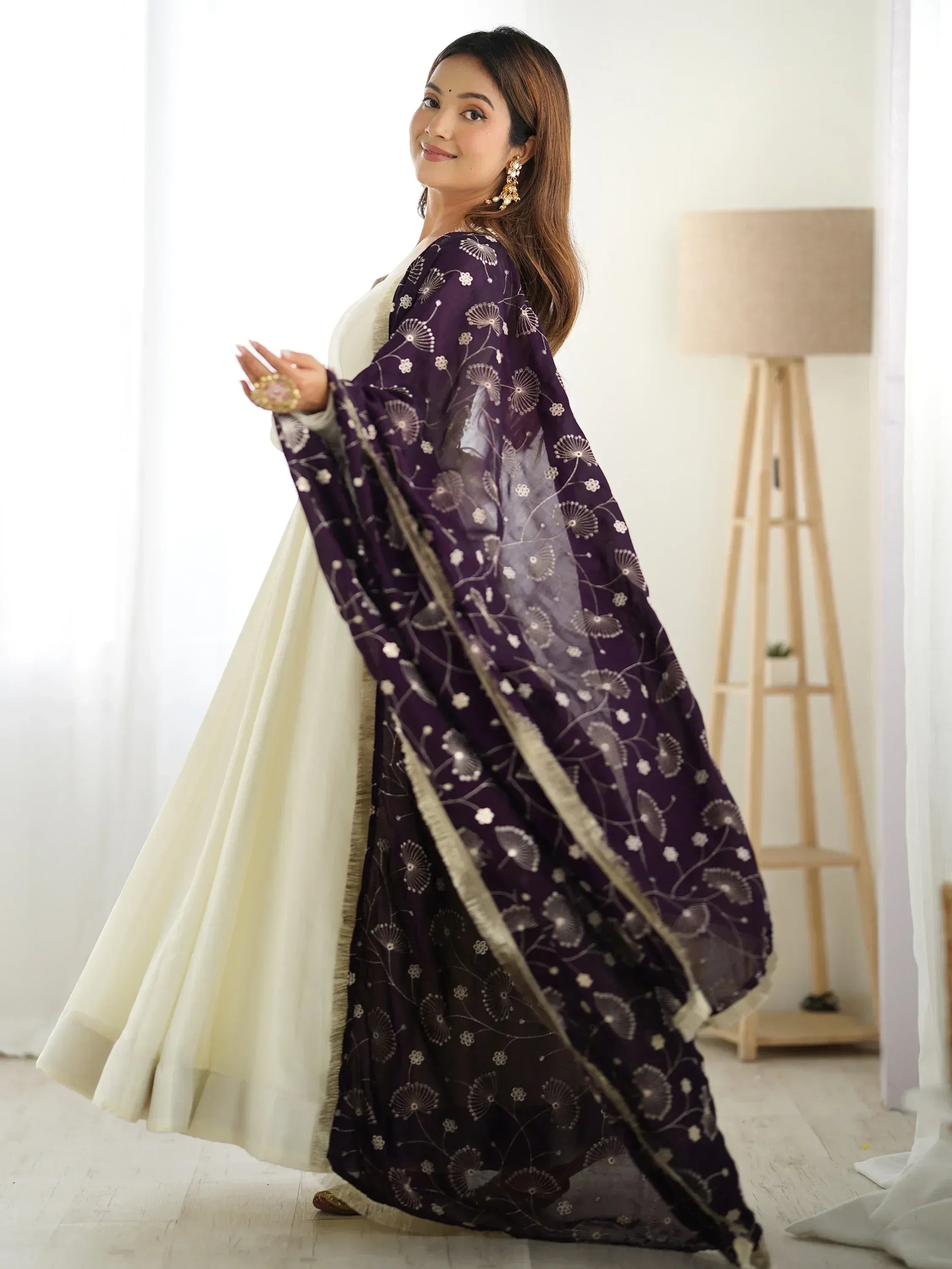 Woman in cream anarkali with purple floral dupatta, Indian ethnic wear
