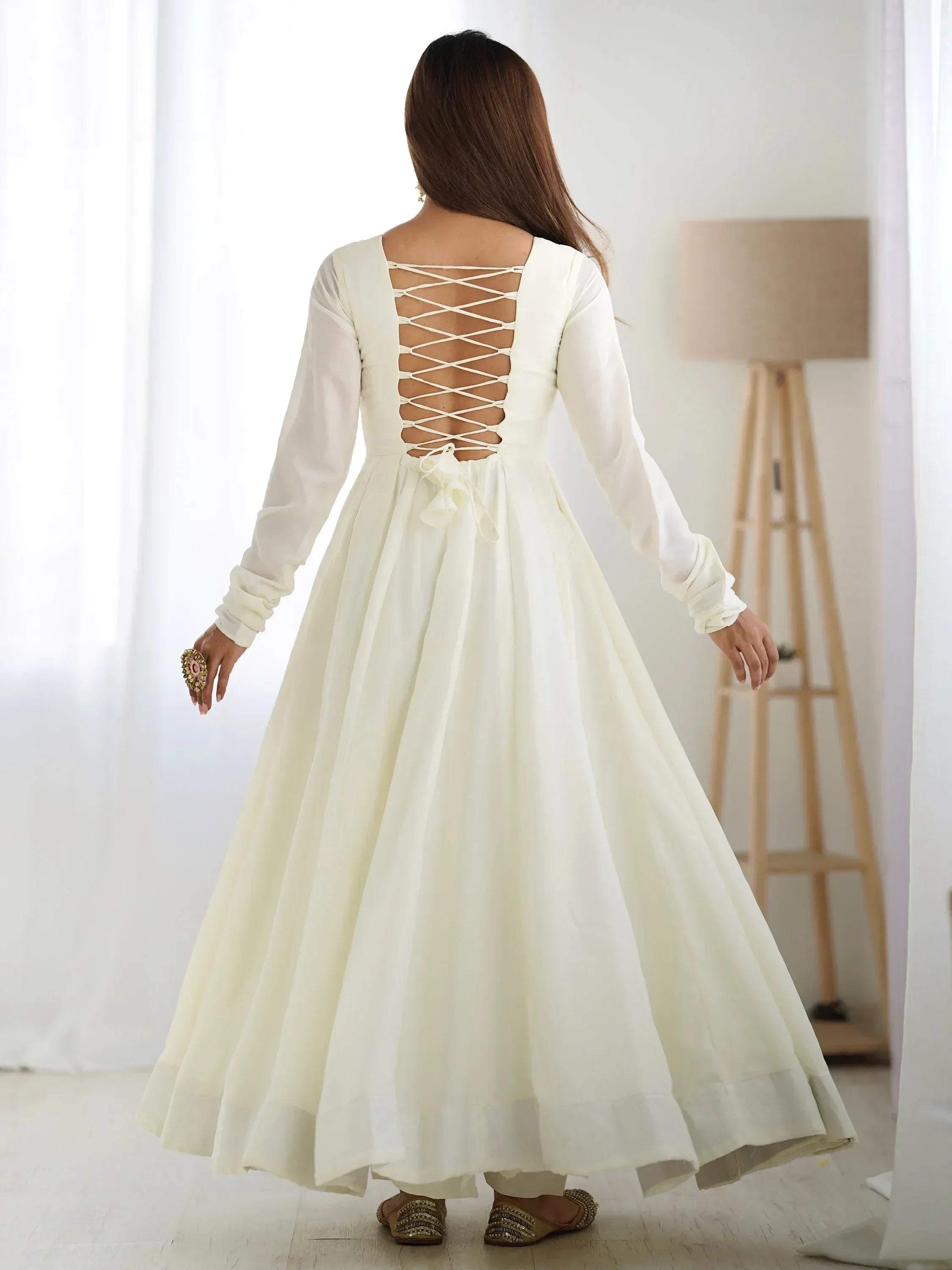 White ethnic gown with lace-up back, long sleeves, and flared skirt for Indian wear