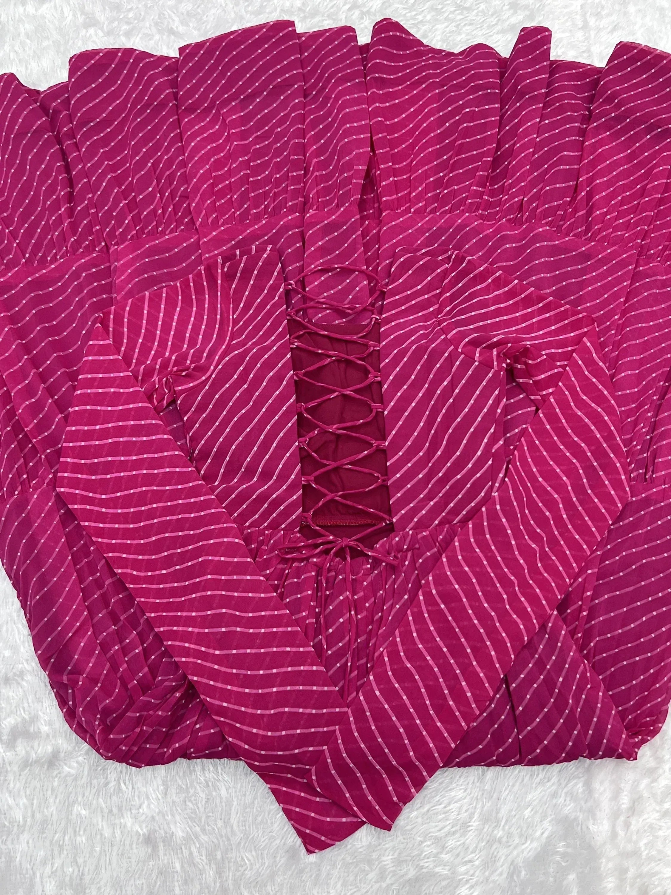 Fuchsia ethnic gown with white stripe print and lace-up back, ideal for Indian festive wear
