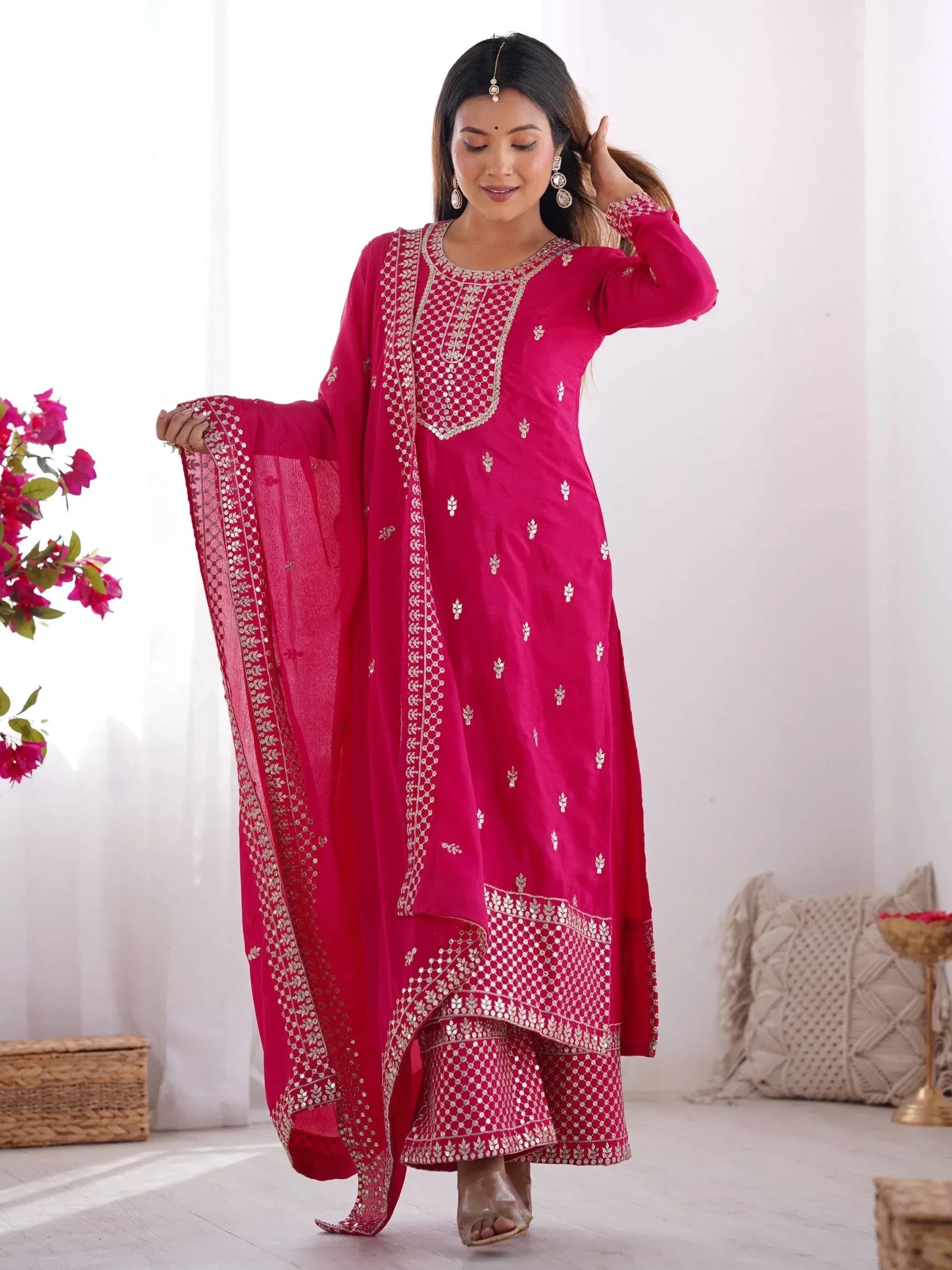 Elegant pink embroidered salwar kameez with matching dupatta, perfect for festive occasions.