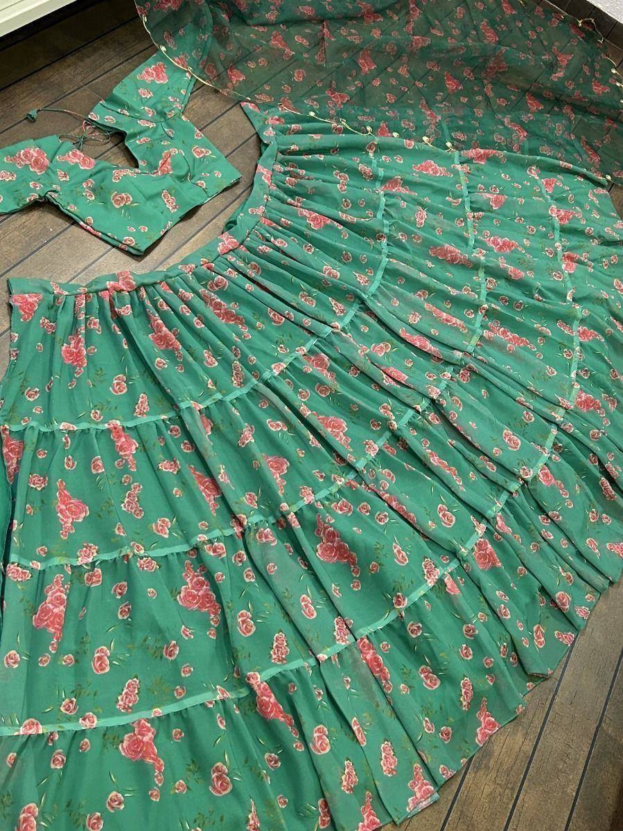 Green floral printed tiered lehenga choli set with pink rose pattern, ideal for ethnic wear occasions