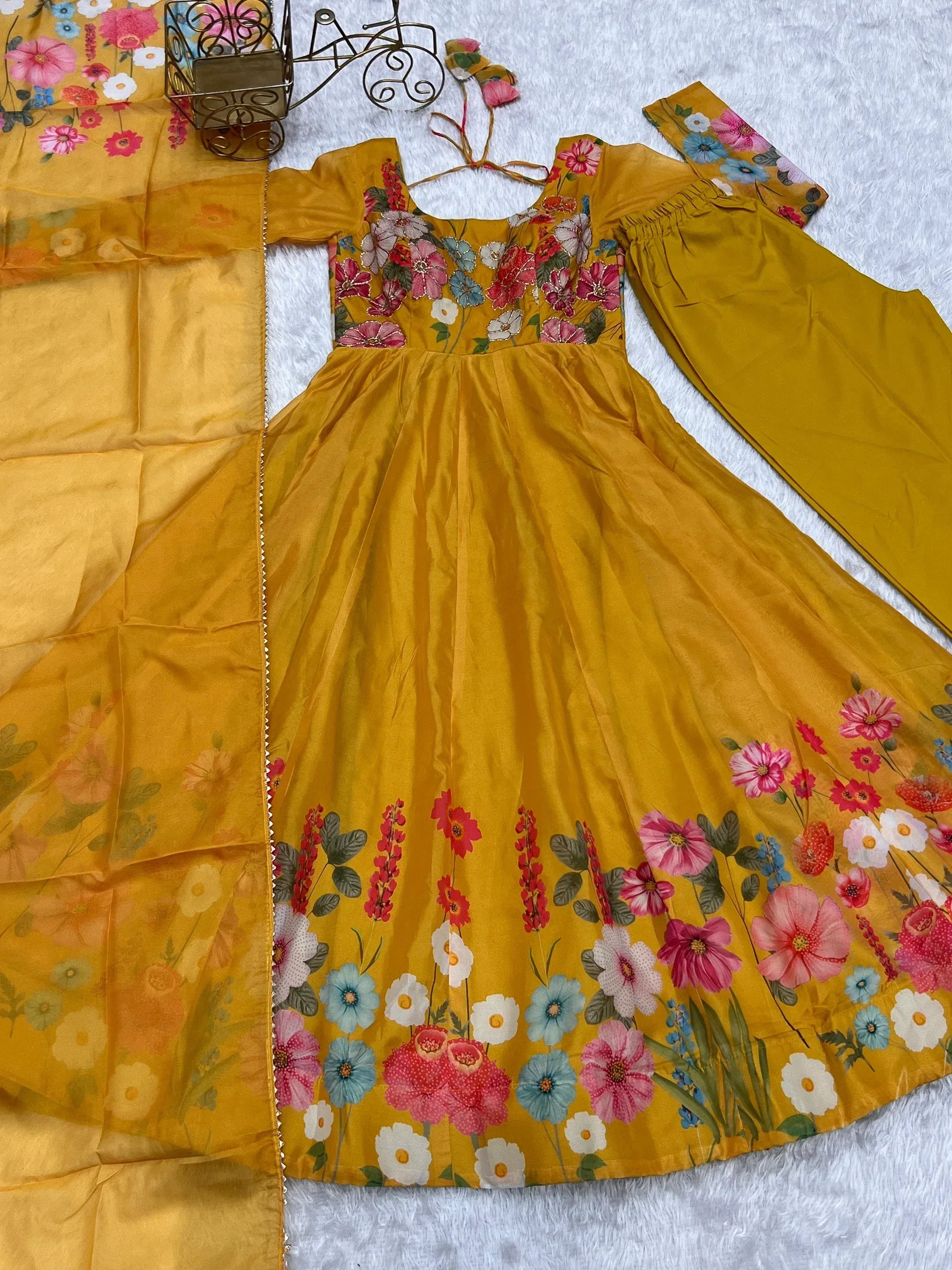 Yellow floral ethnic gown with matching dupatta and pants, perfect for festive occasions.