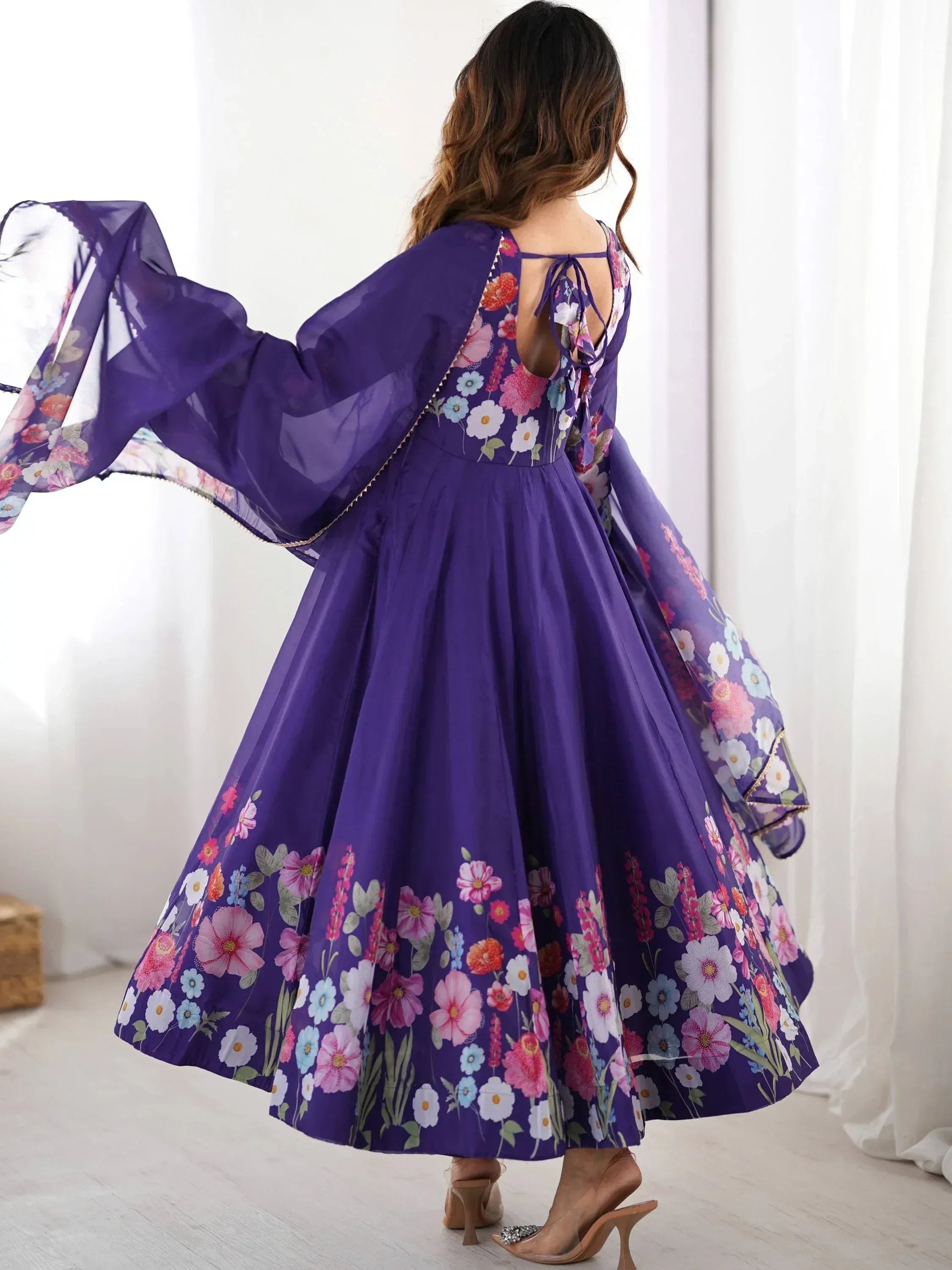 Purple floral ethnic gown with sheer sleeves and back tie, perfect for Indian occasions