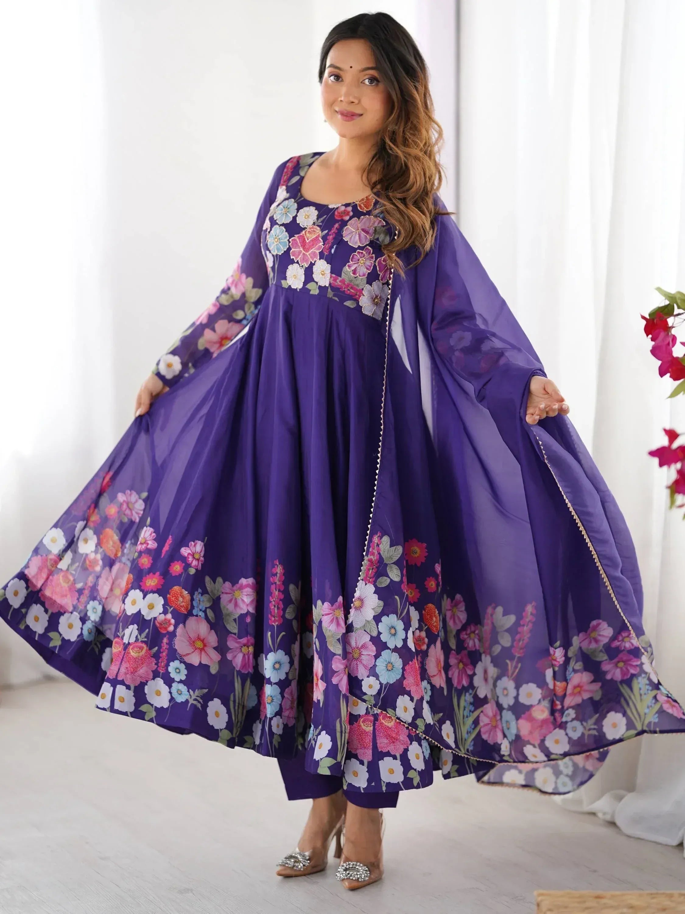 Purple floral print ethnic gown with cape sleeves, perfect for Indian occasions and festive wear.