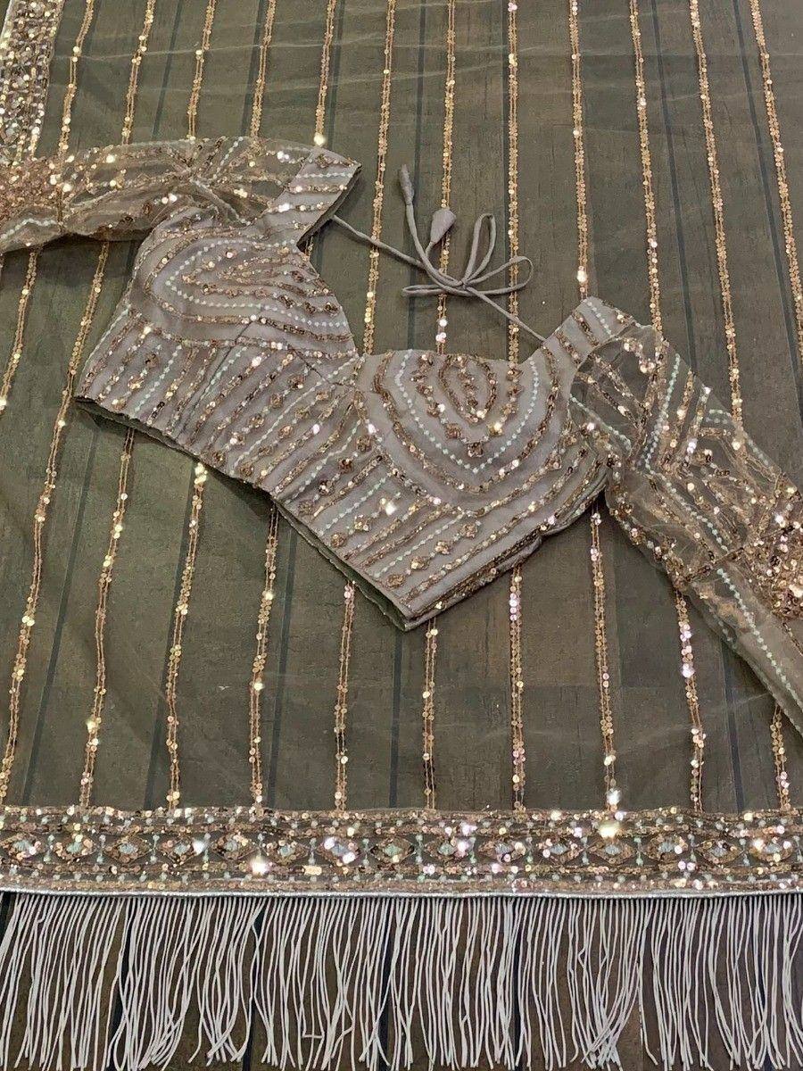Grey sequin lehenga choli with gold embroidery and fringe detailing, perfect for Indian ethnic wear events.