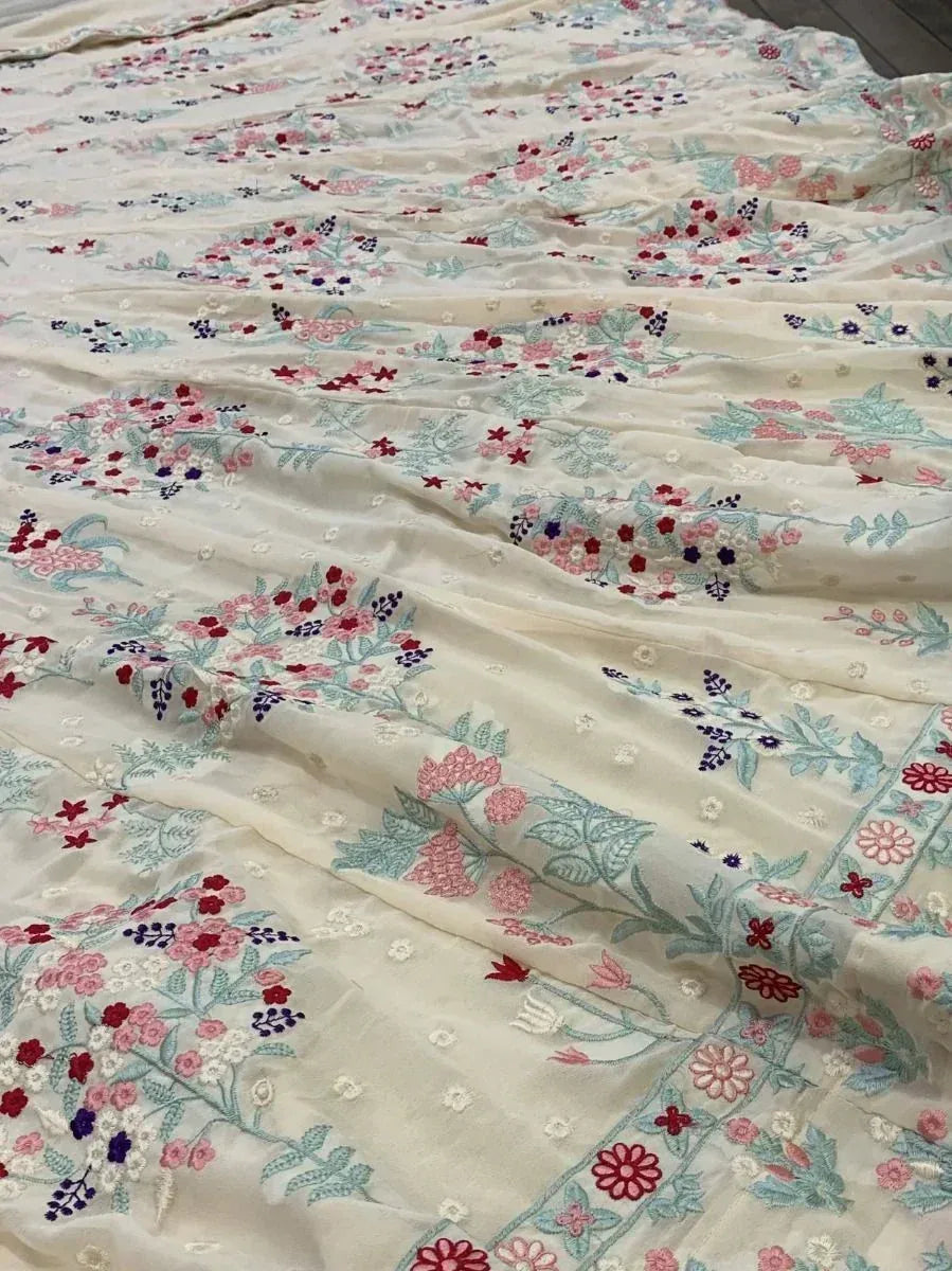 Floral embroidered ethnic fabric with pastel hues and intricate designs