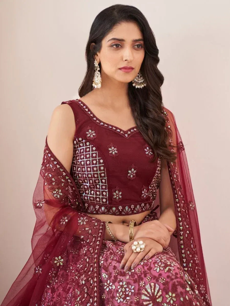 Maroon embroidered lehenga choli with floral motifs and sheer dupatta, perfect for Indian ethnic occasions