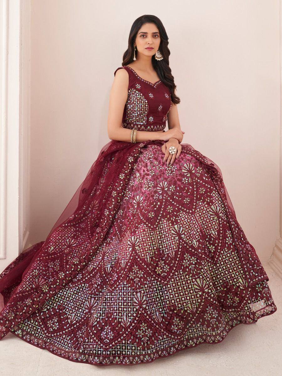 Maroon designer lehenga choli with intricate embroidery and embellishments, perfect for weddings and festive occasions