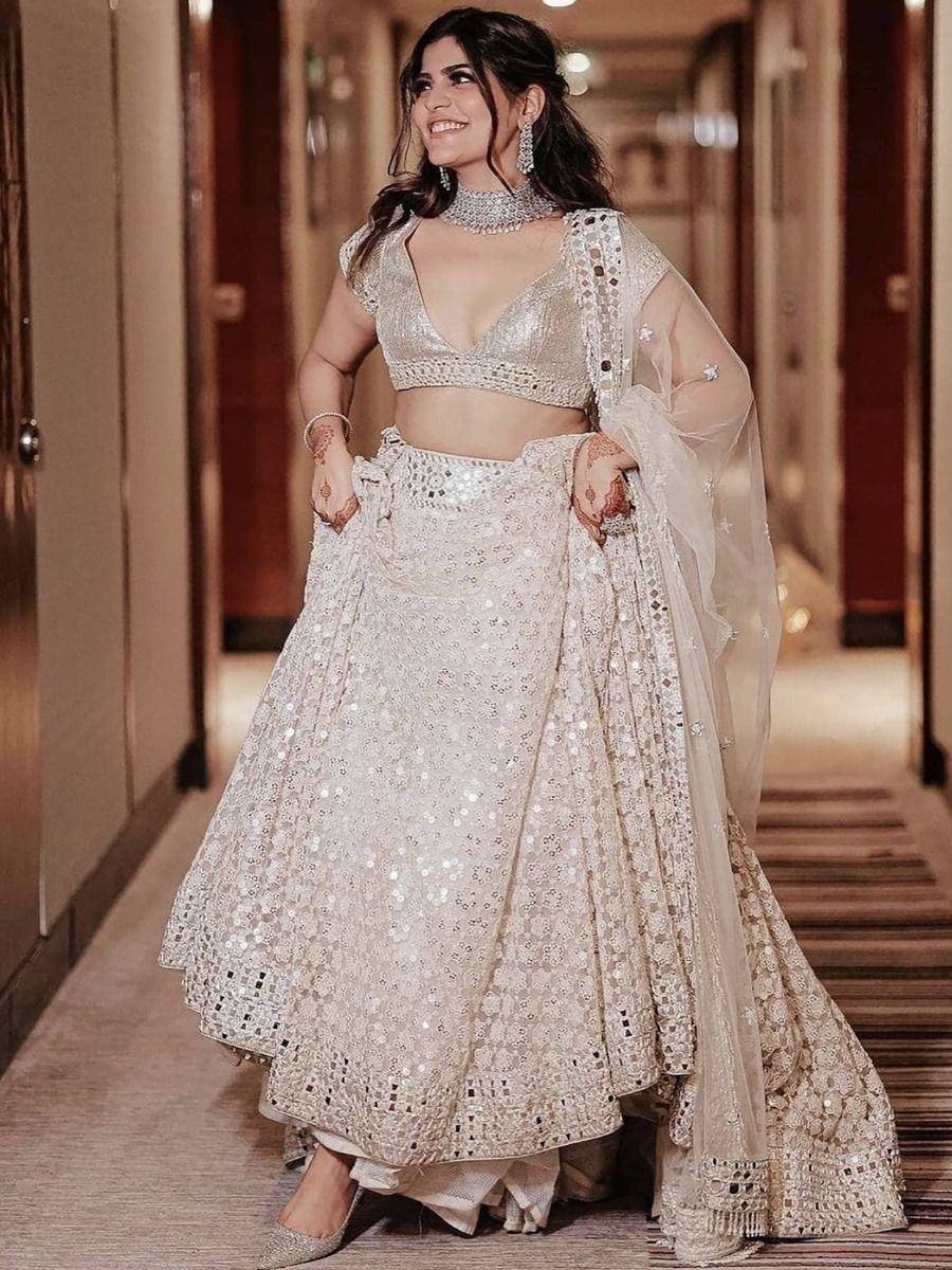 Elegant ivory lehenga choli with mirror work, perfect for weddings and festive occasions