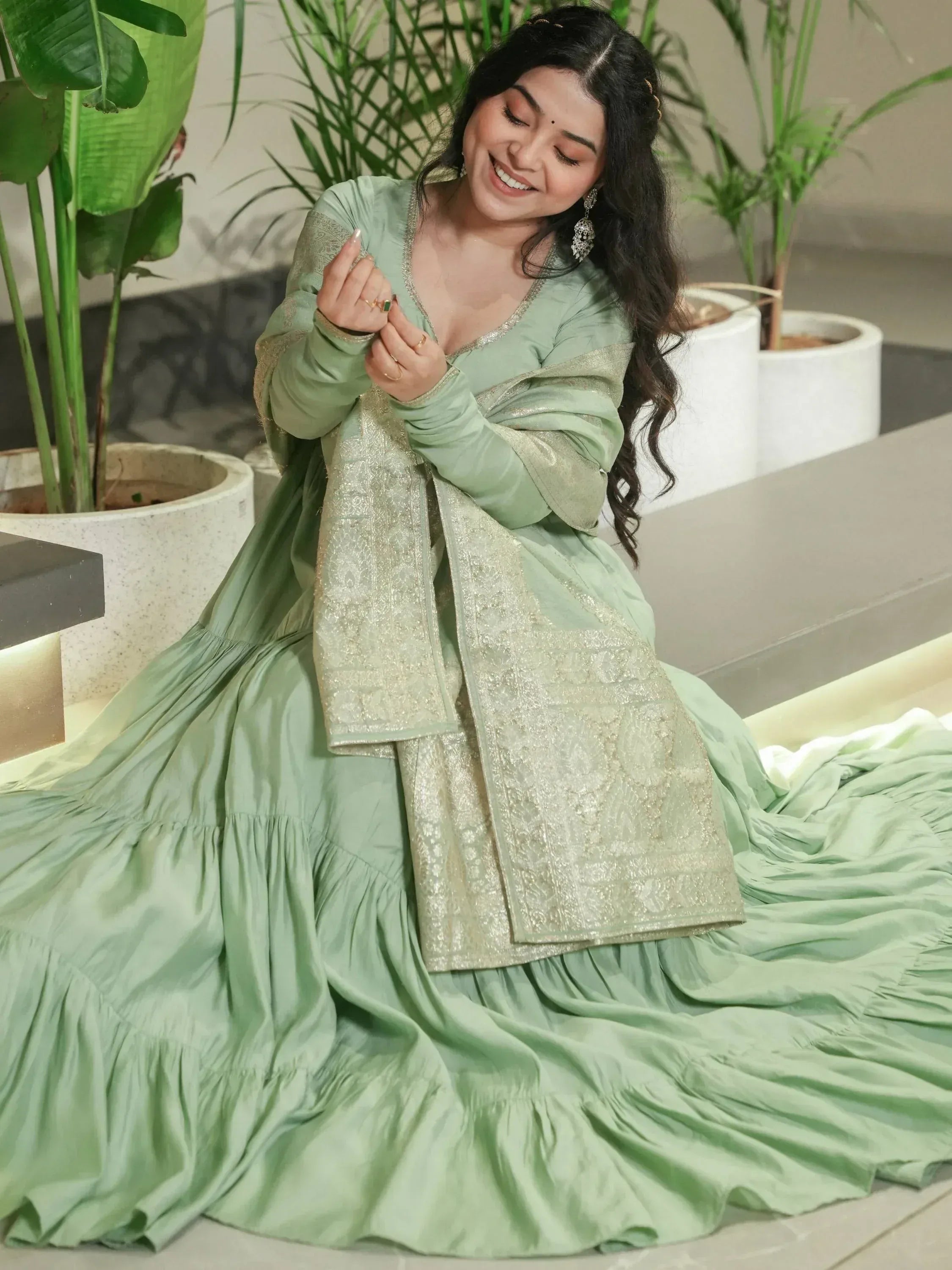 Mint green ethnic gown with gold embroidery, perfect for Indian occasions and festive wear.