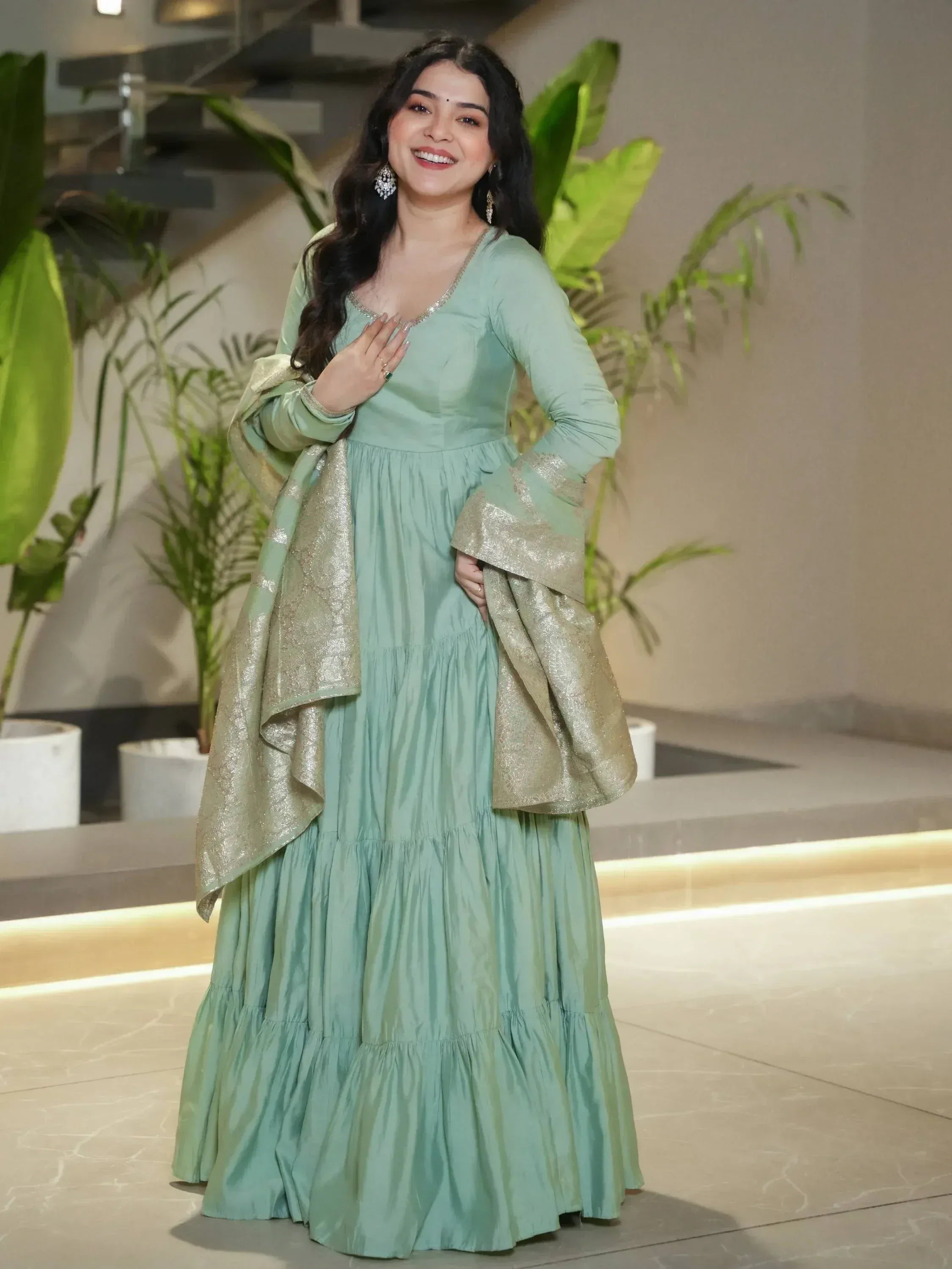 Mint green ethnic gown with gold dupatta, perfect for Indian occasions and festive wear