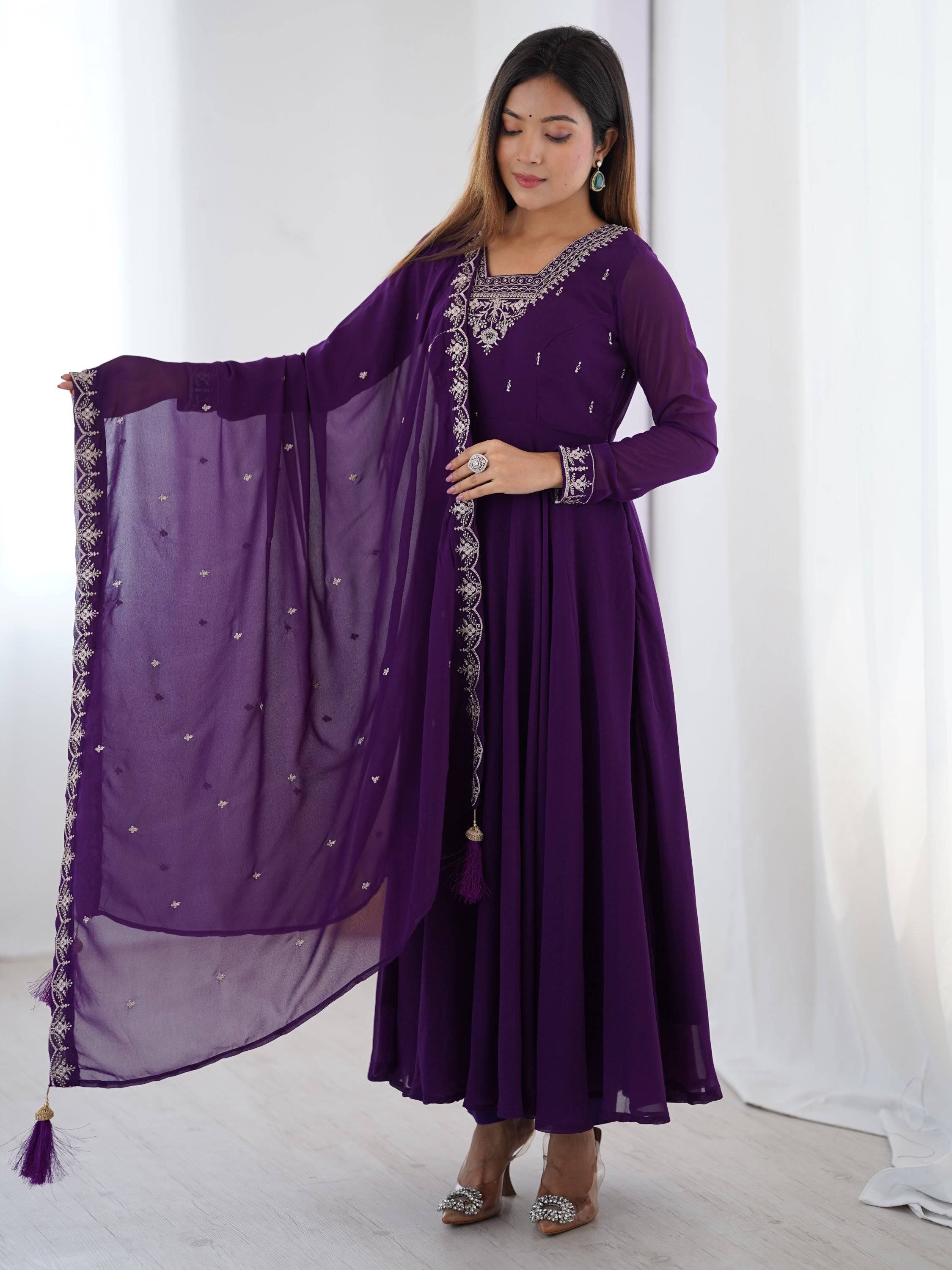Purple ethnic gown with intricate embroidery and matching dupatta for festive occasions