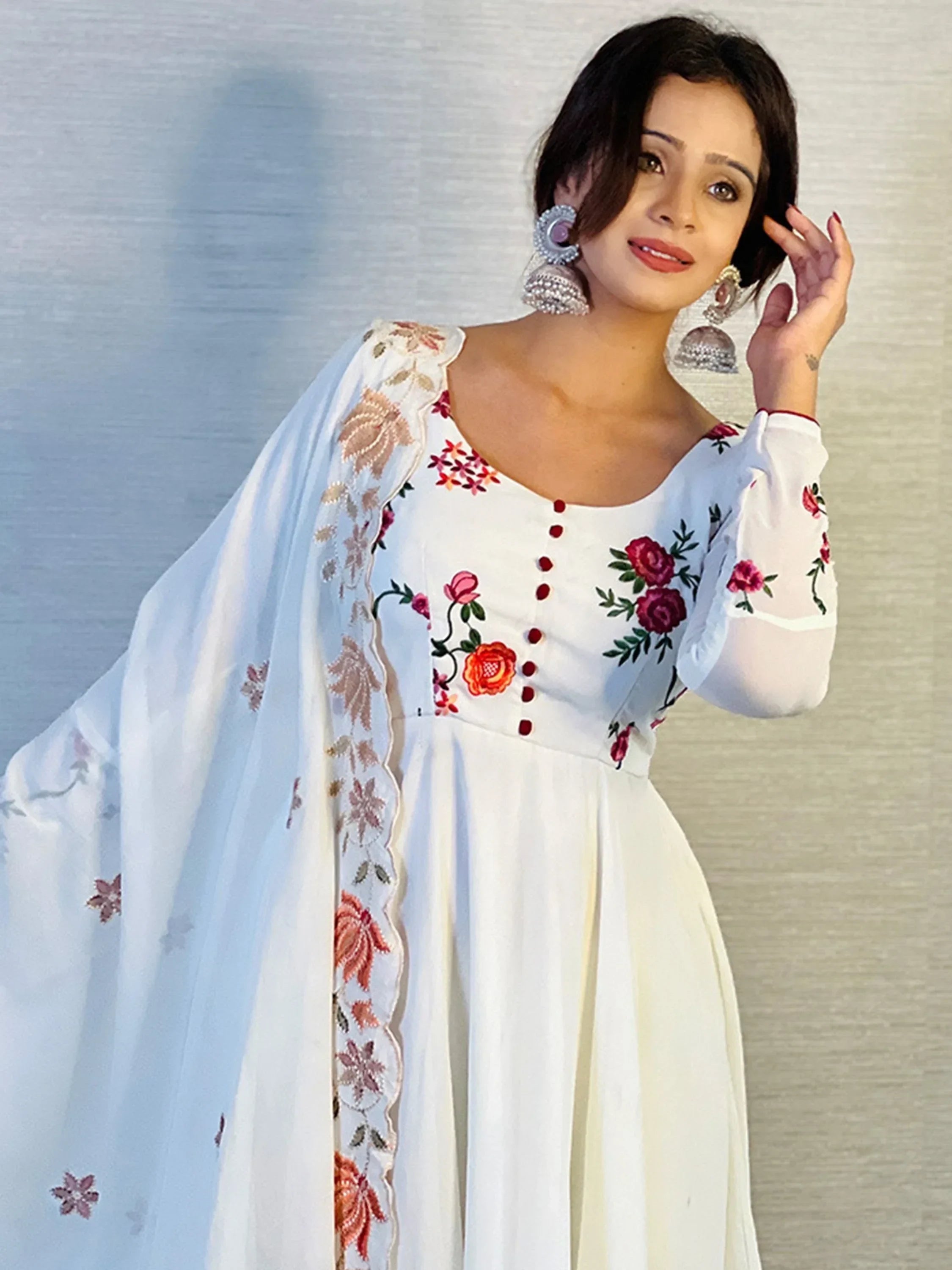 Woman wearing white ethnic gown with floral embroidery and matching dupatta