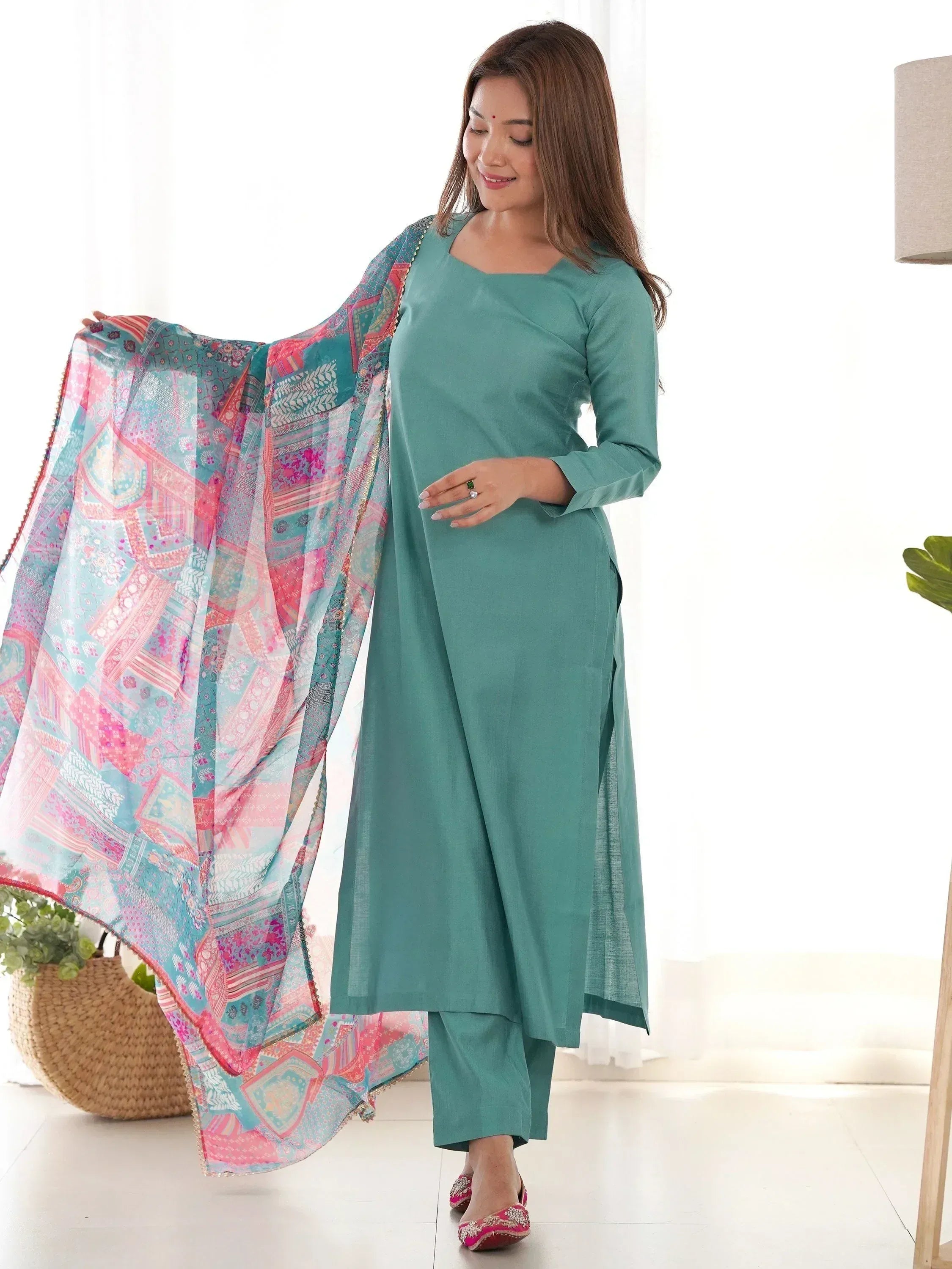 Teal Indian ethnic kurta with matching pants and colorful printed dupatta, styled for women