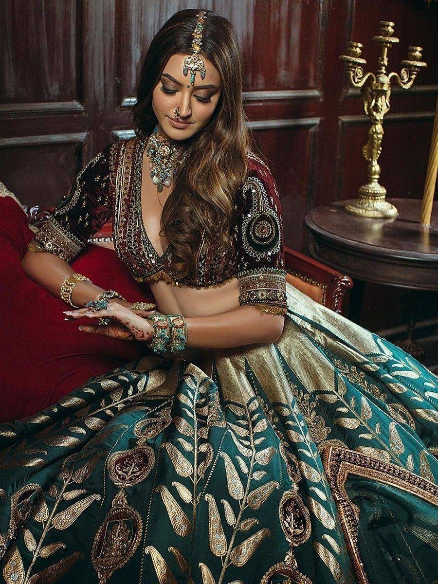 Elegant Indian bridal lehenga choli with intricate gold embroidery, perfect for weddings and festive occasions.
