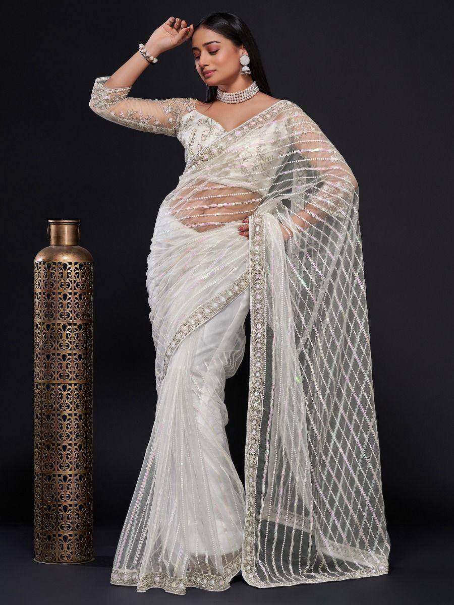 Elegant white embroidered saree with sheer blouse, perfect for Indian ethnic wear and festive occasions.