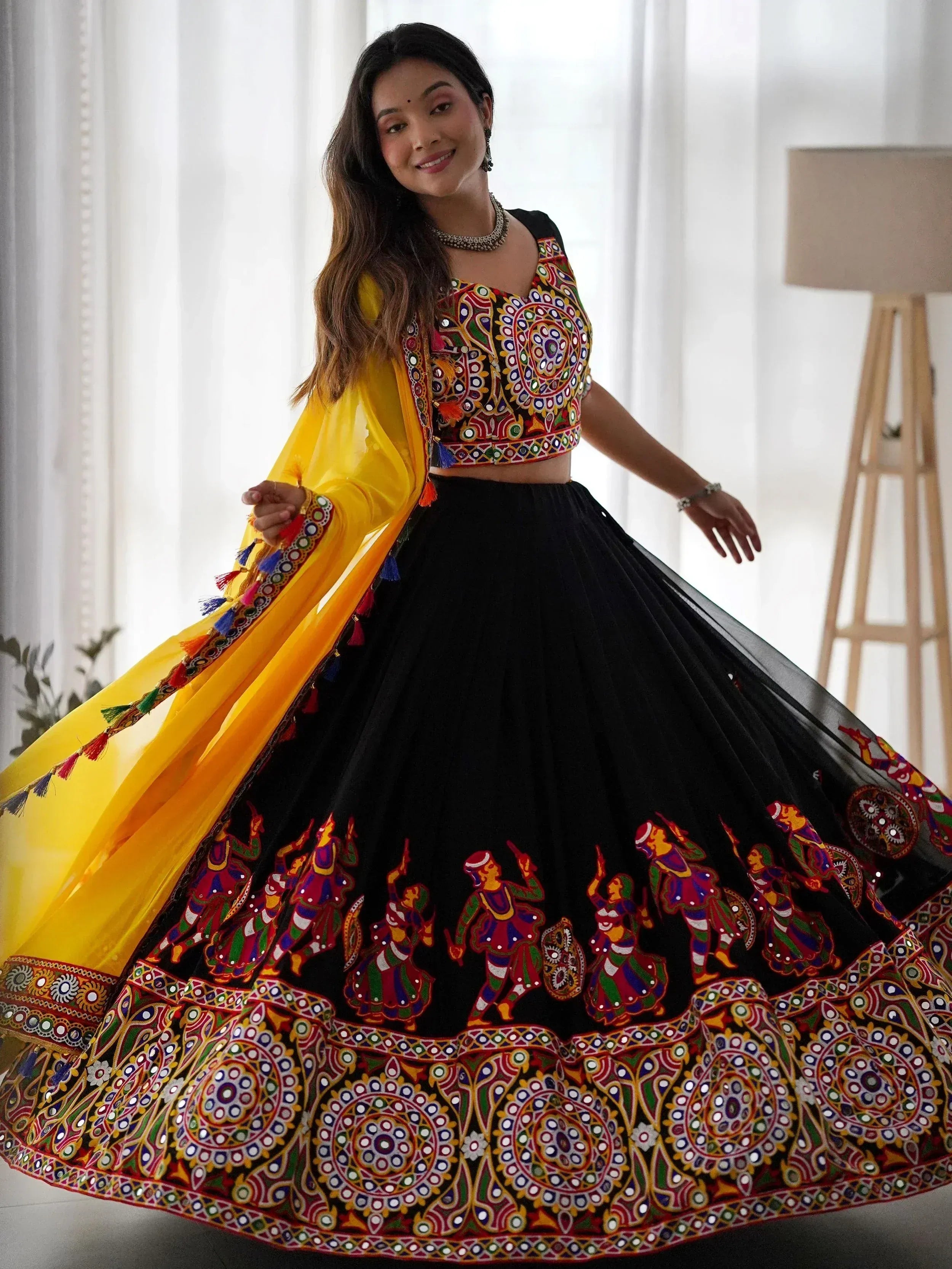 Black embroidered lehenga choli with mirror work, yellow dupatta, Indian ethnic wear for women