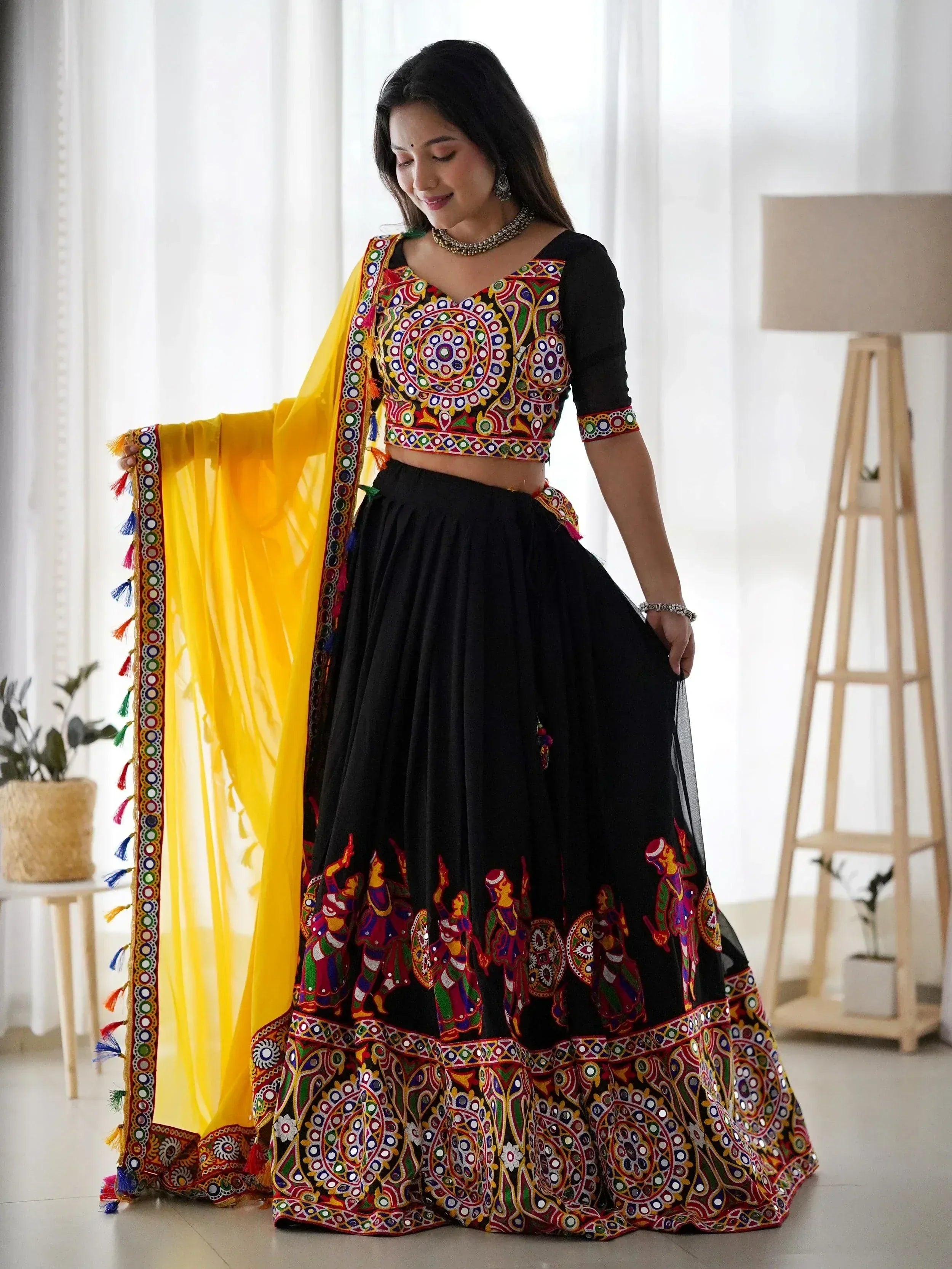 Black embroidered lehenga choli with colorful mirror work and yellow dupatta, Indian ethnic wear