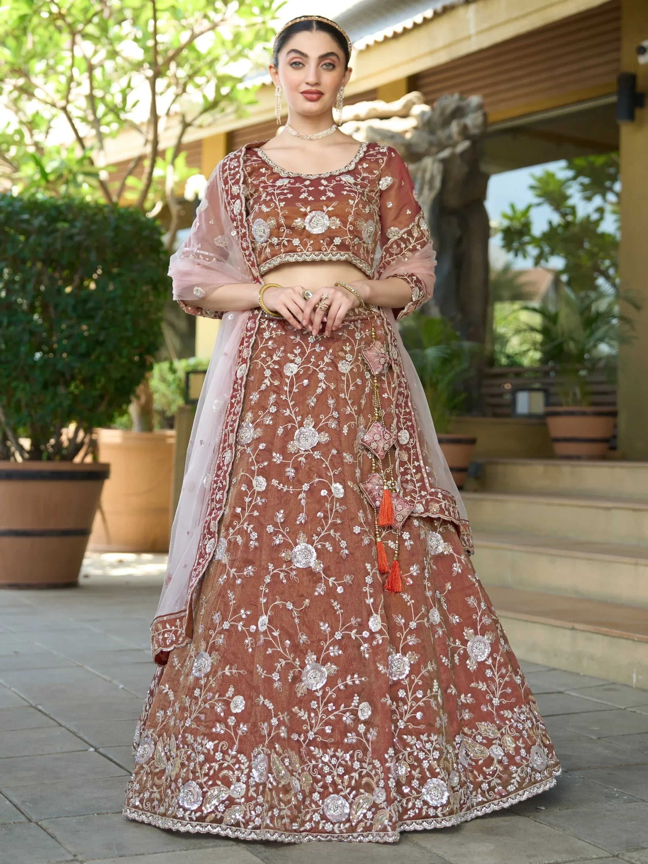 Elegant maroon lehenga choli with floral embroidery, perfect for Indian weddings and festive occasions.