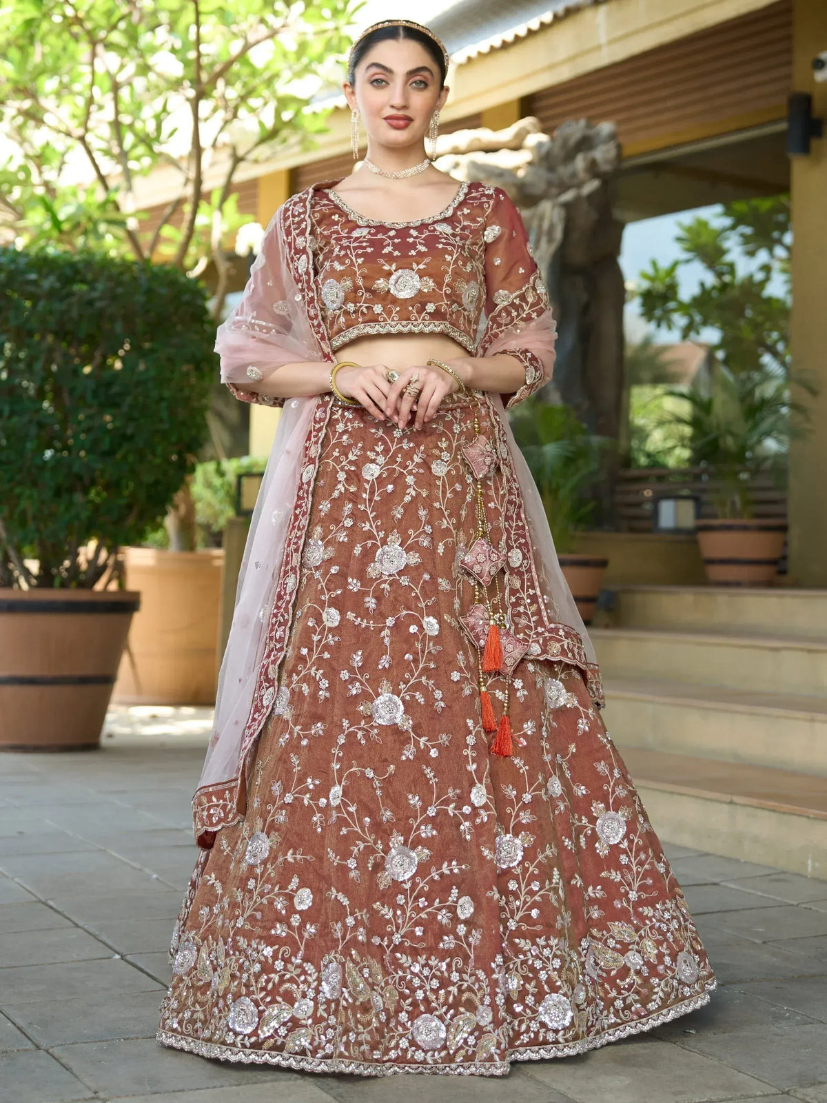 Elegant maroon lehenga choli with floral embroidery, perfect for Indian weddings and festive occasions.