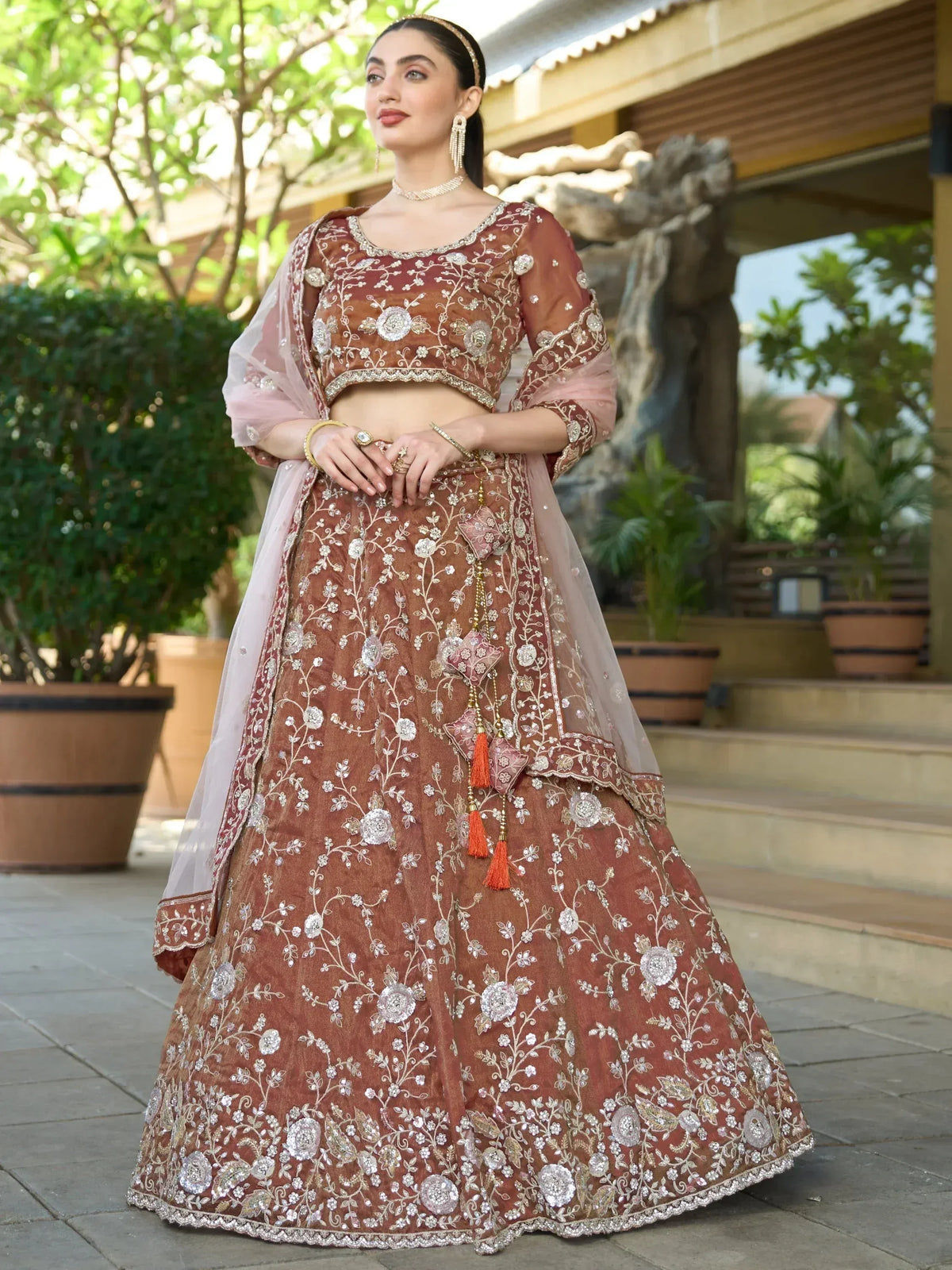 Elegant maroon lehenga choli with floral embroidery, perfect for Indian weddings and festive occasions.