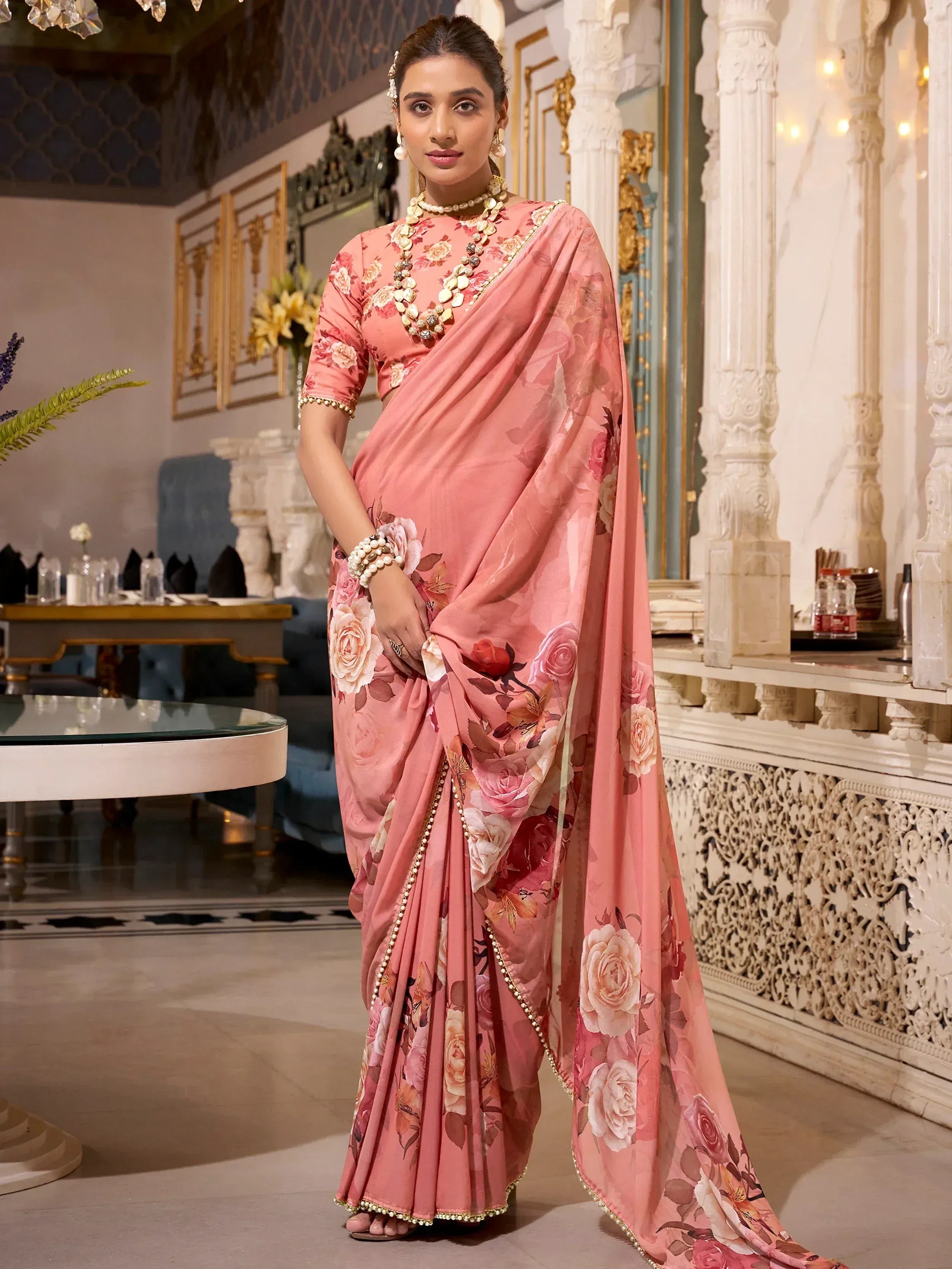 Pink floral saree with gold trim, elegant Indian ethnic wear for festive occasions