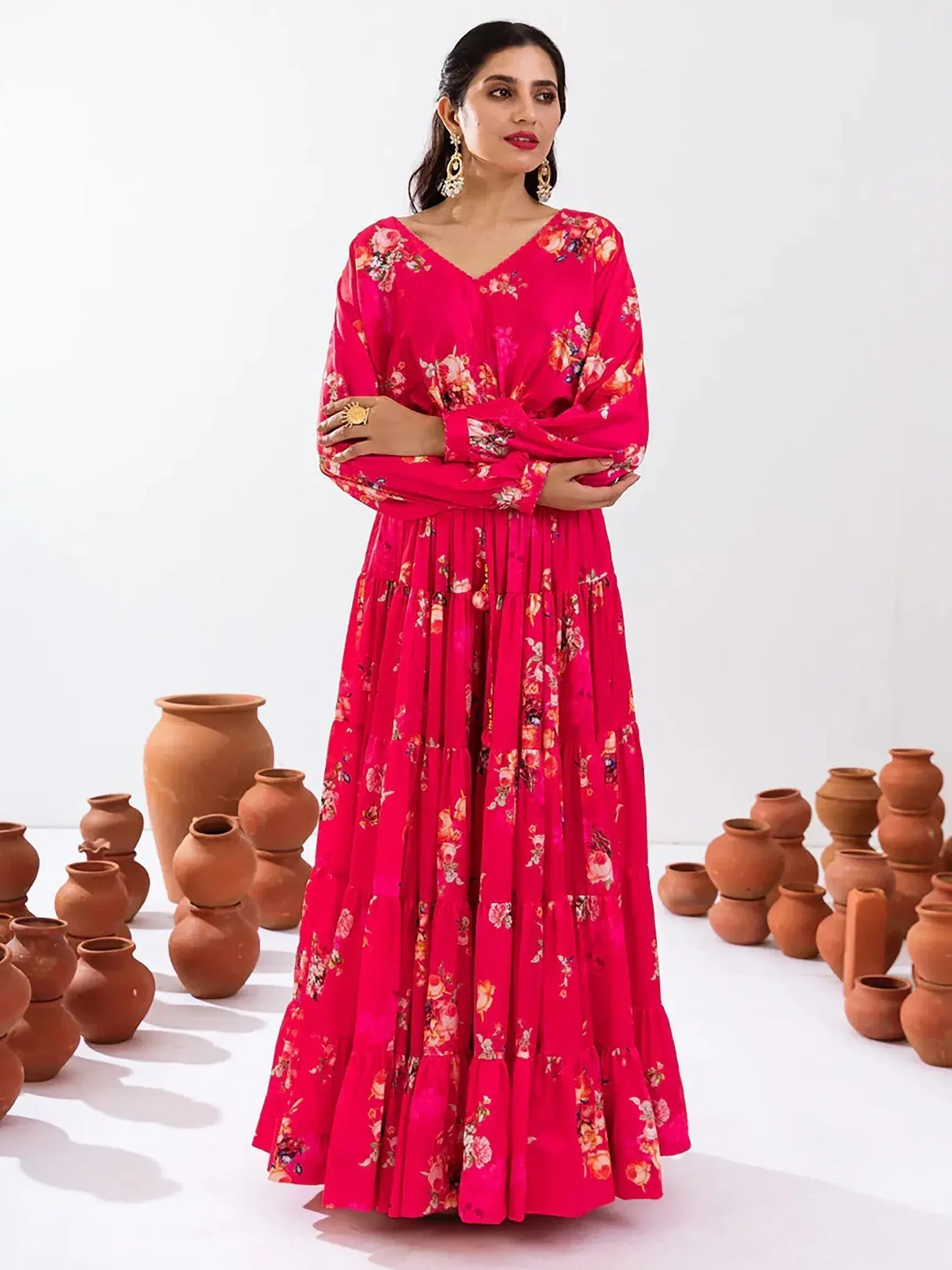 Vibrant pink floral ethnic gown with tiered skirt, perfect for Indian occasions and festive wear.