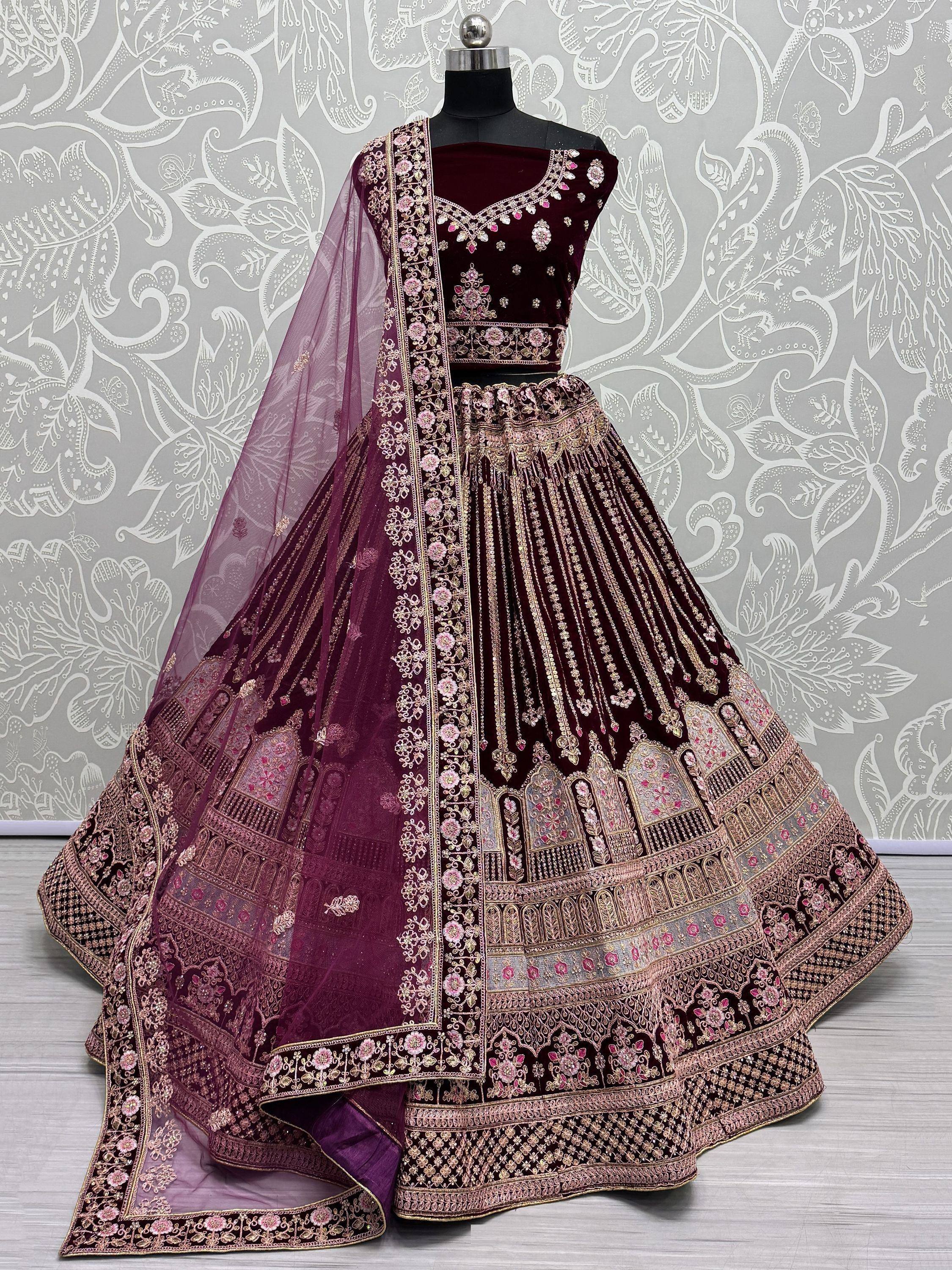 Elegant maroon lehenga choli with intricate gold and pink embroidery, perfect for Indian ethnic wear.