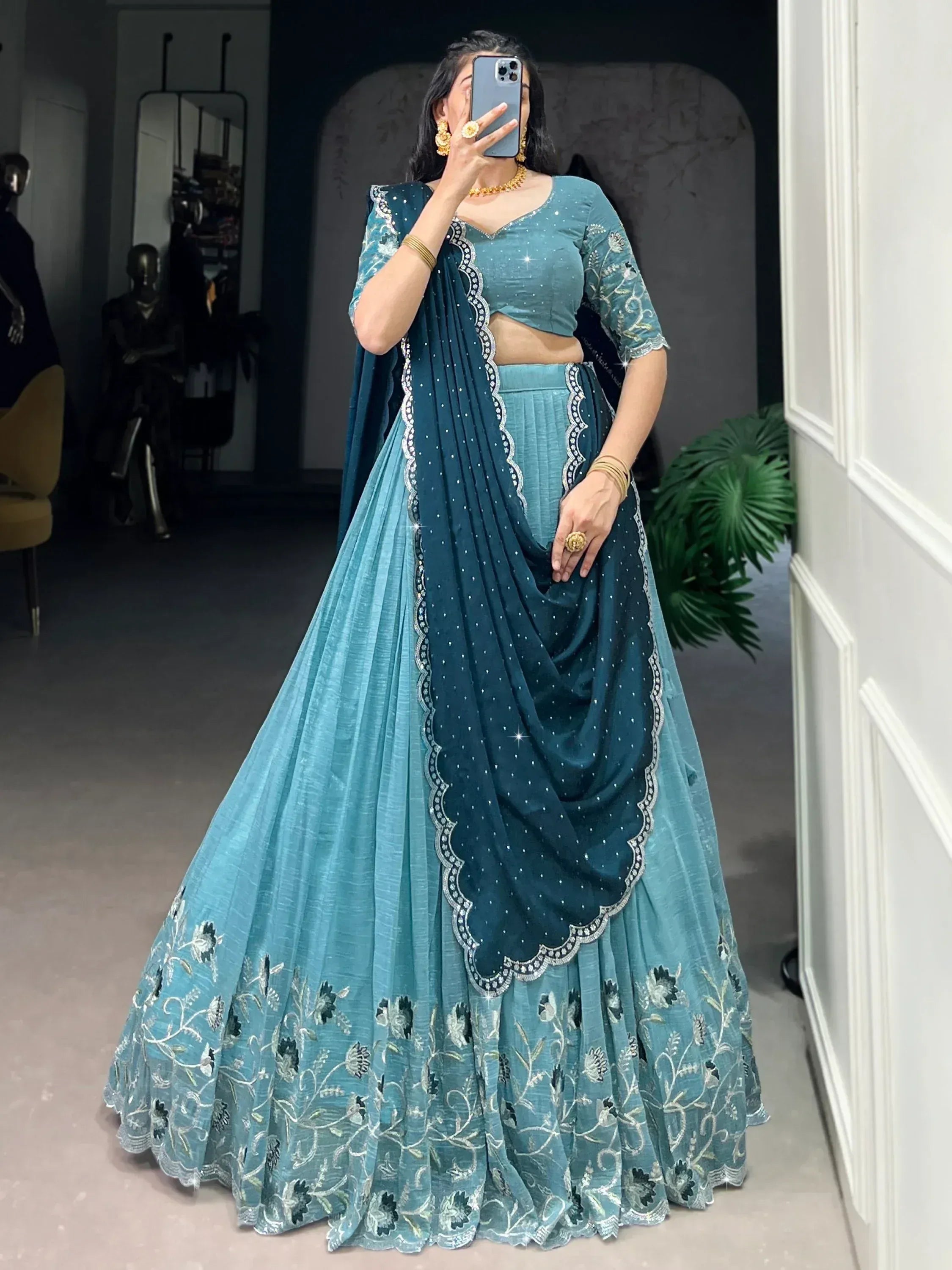 Teal blue embroidered lehenga choli with floral detailing and scalloped dupatta, perfect for Indian ethnic wear