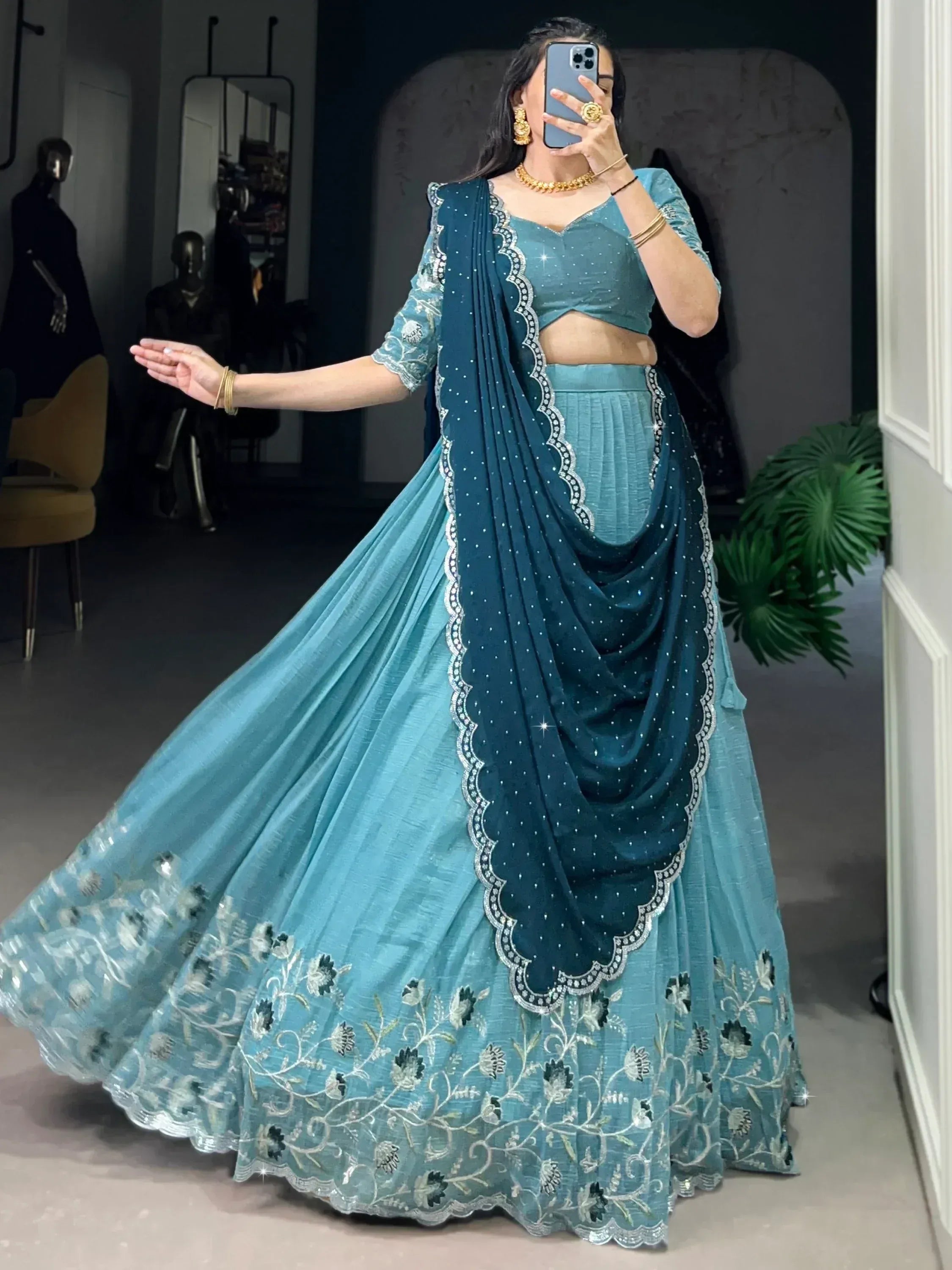 Teal designer lehenga choli with floral embroidery and sequin dupatta, perfect for Indian ethnic wear occasions.