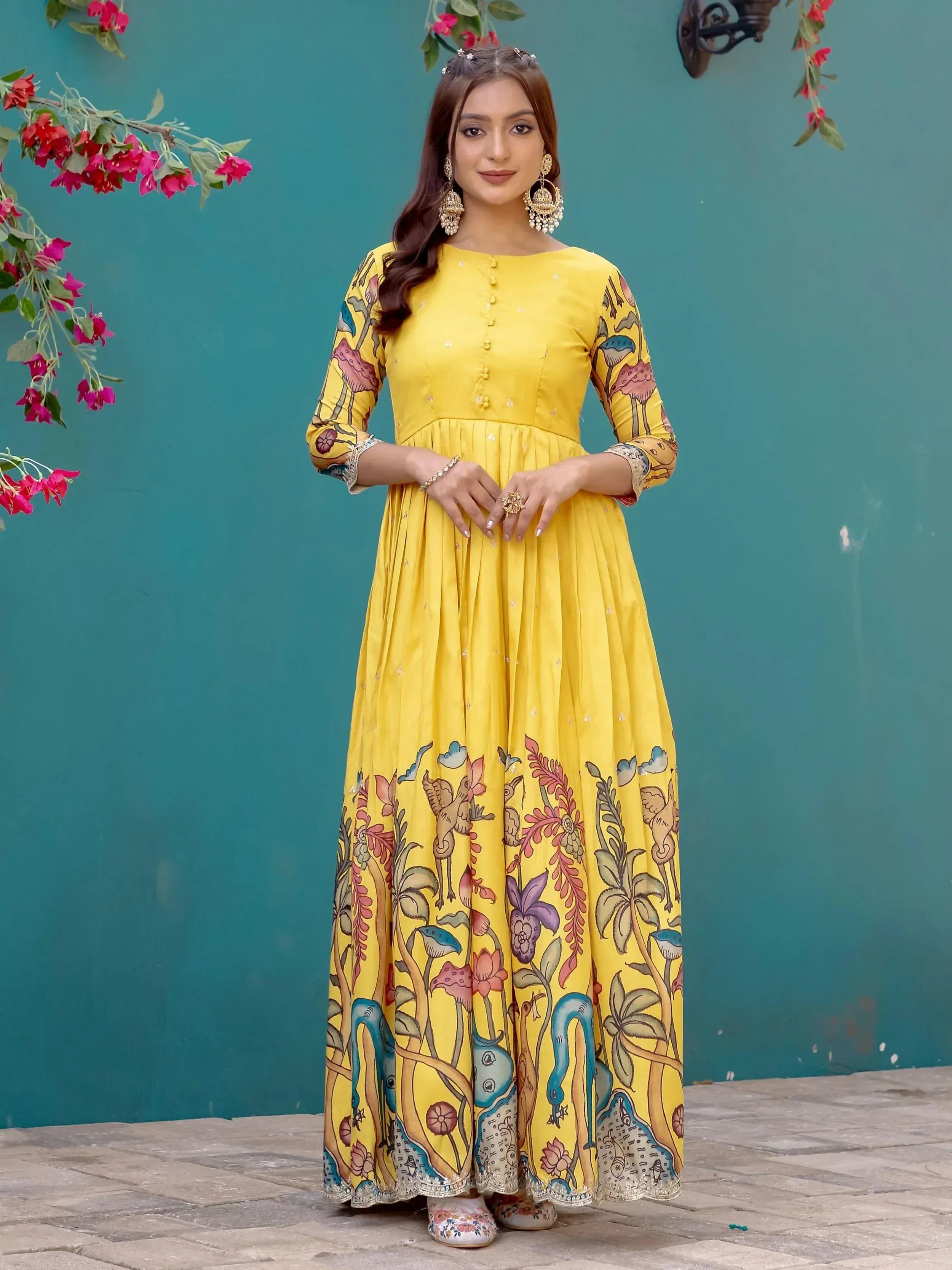 Yellow printed ethnic gown with floral and bird motifs, perfect for Indian festive occasions