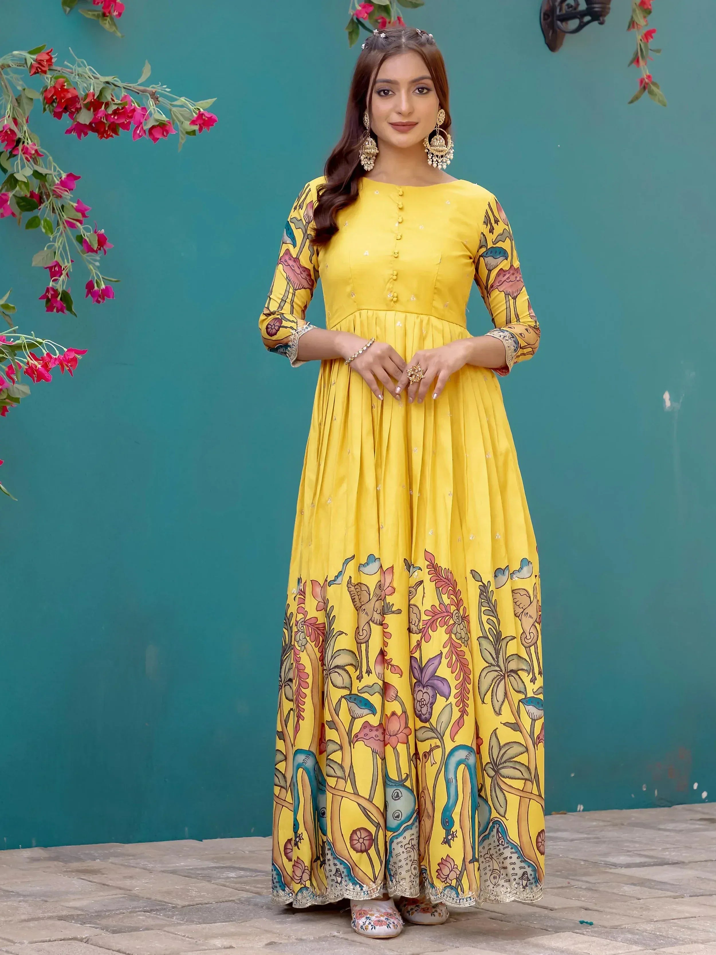 Yellow printed ethnic gown with floral and bird motifs, perfect for Indian occasions and festive wear.