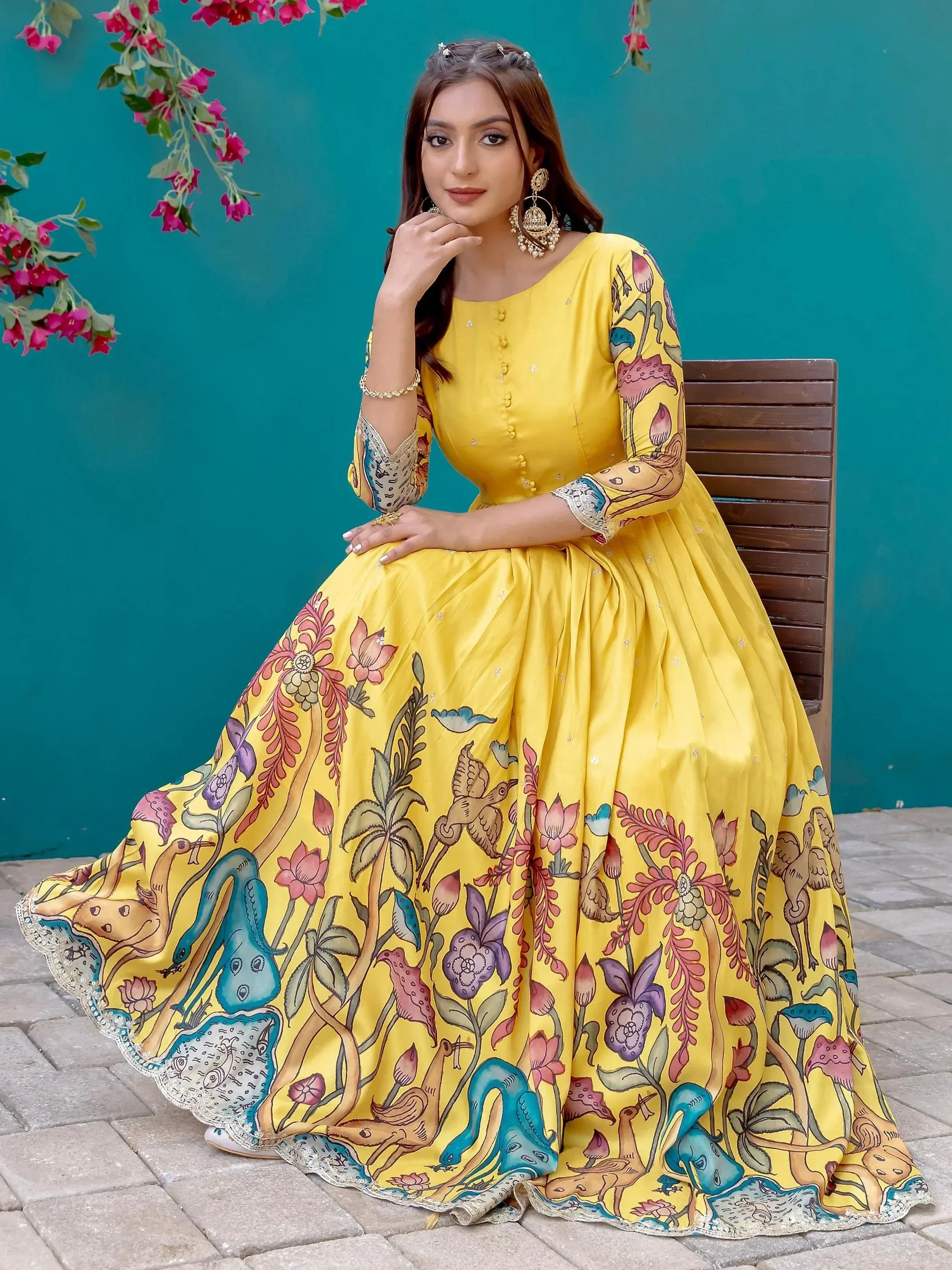 Yellow floral print ethnic gown with bird motifs, perfect for Indian celebrations and festive occasions.