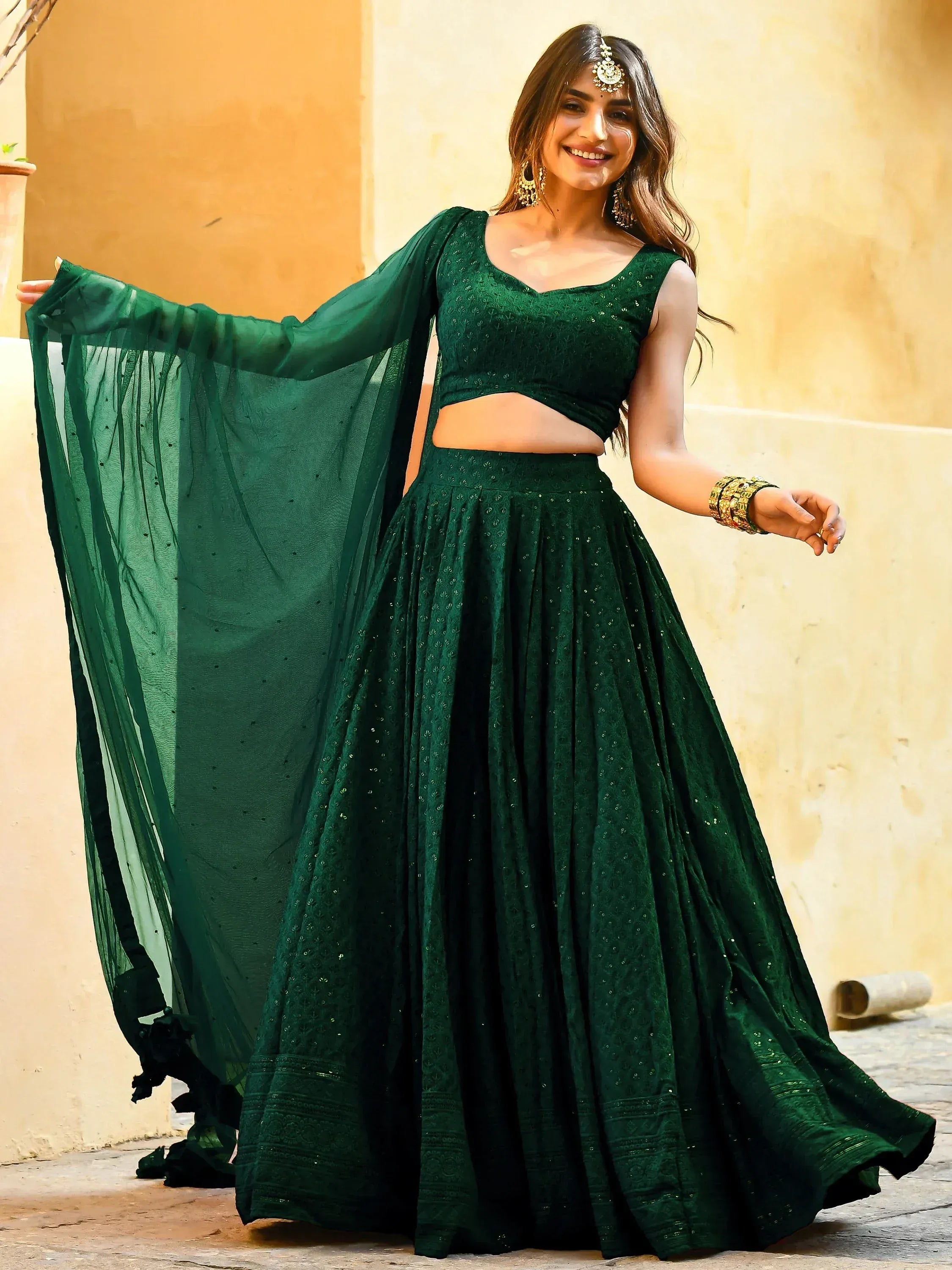 Emerald green designer lehenga choli with sheer dupatta, perfect for Indian ethnic wear and festive occasions.