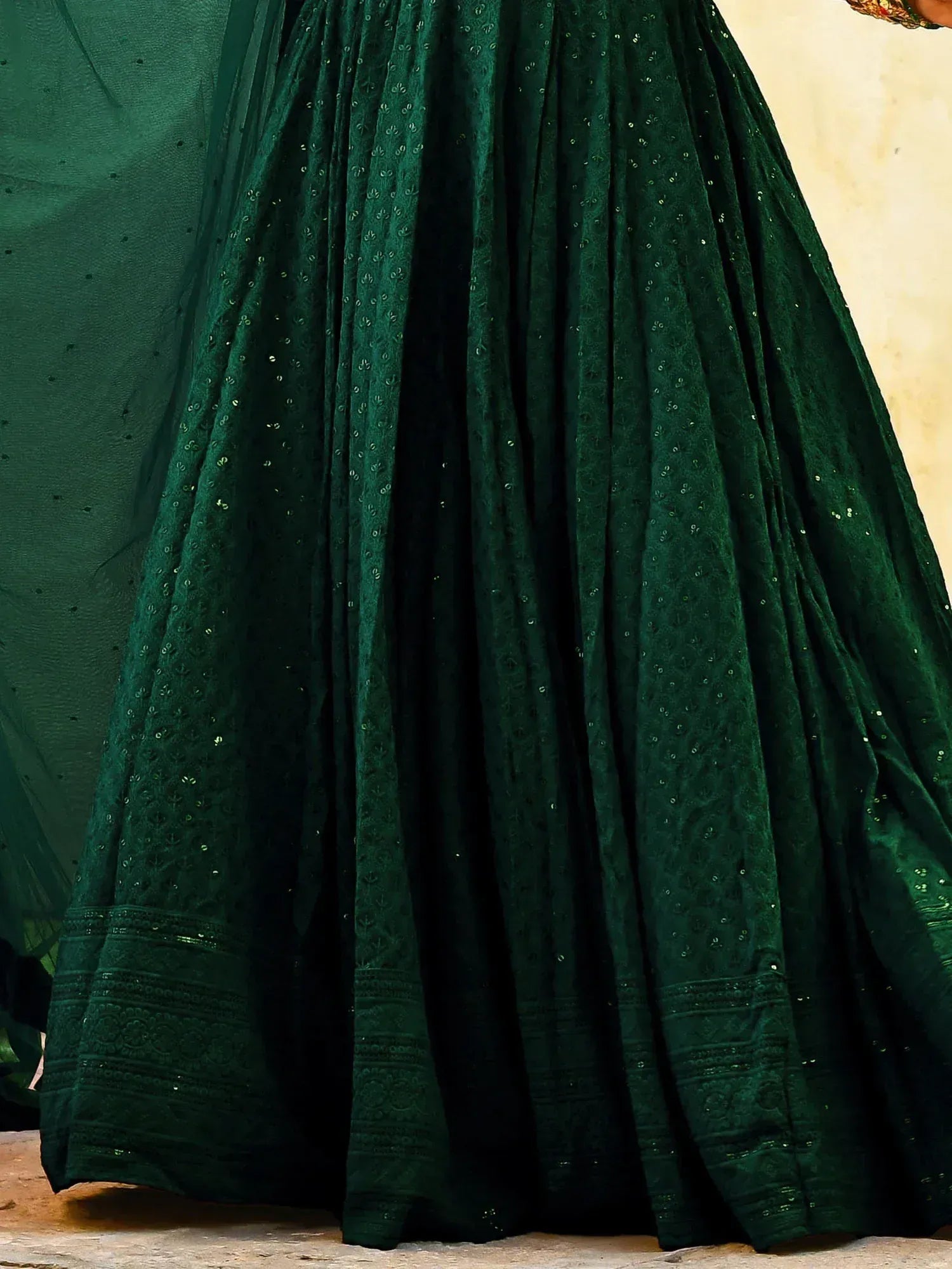 Emerald green lehenga skirt with intricate embroidery and sequin detailing, perfect for Indian ethnic wear.