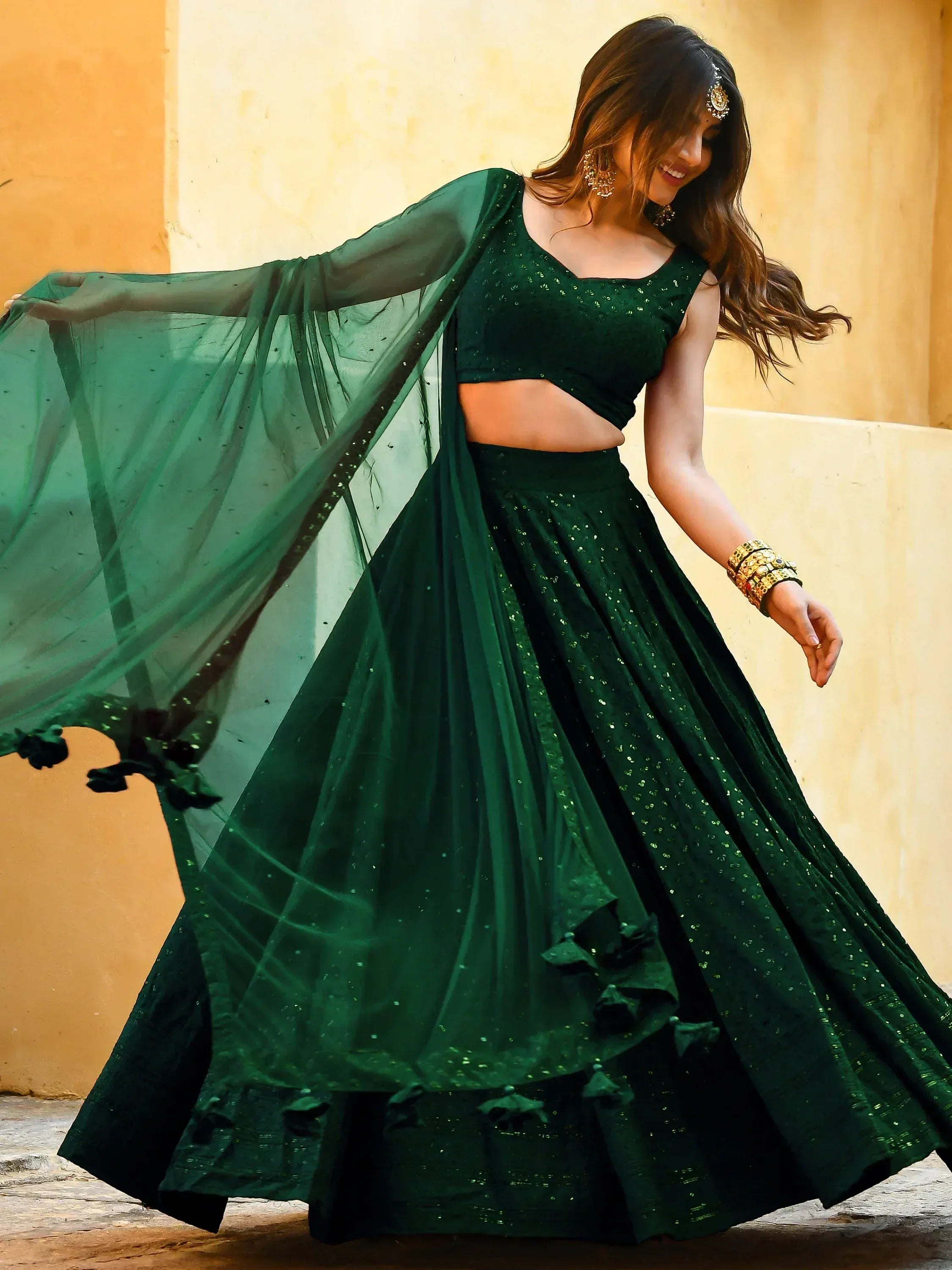 Emerald green designer lehenga choli with sequins, sheer dupatta, and floral trim for Indian ethnic wear