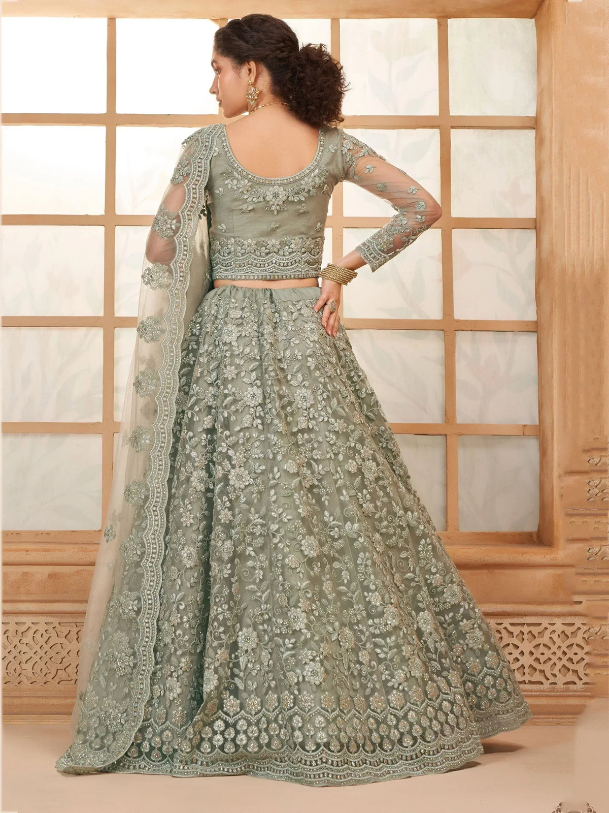 Elegant sage green lehenga choli with floral embroidery and sheer dupatta, perfect for Indian ethnic occasions