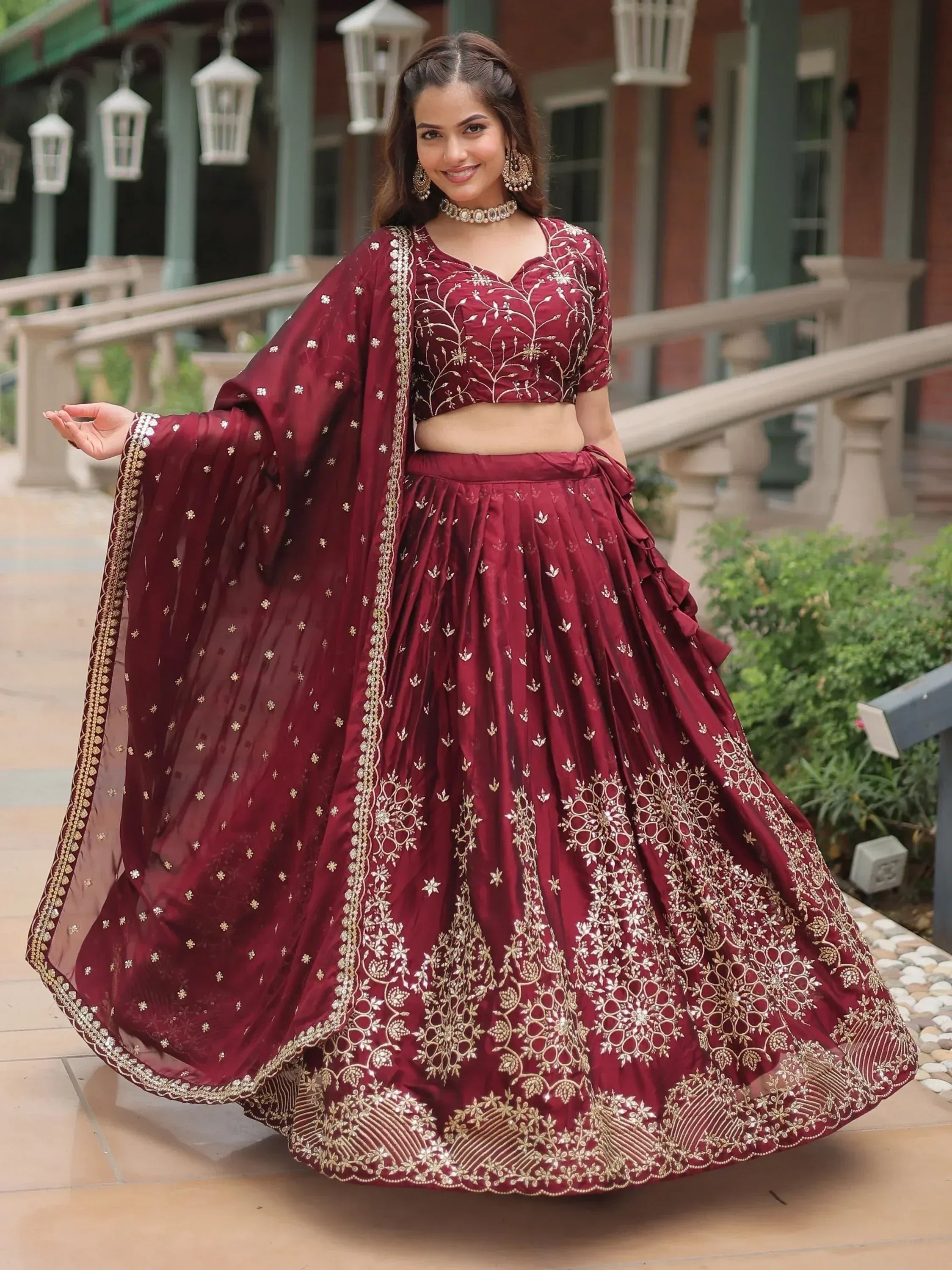 Maroon designer lehenga choli with gold embroidery, perfect for Indian weddings and festive occasions.
