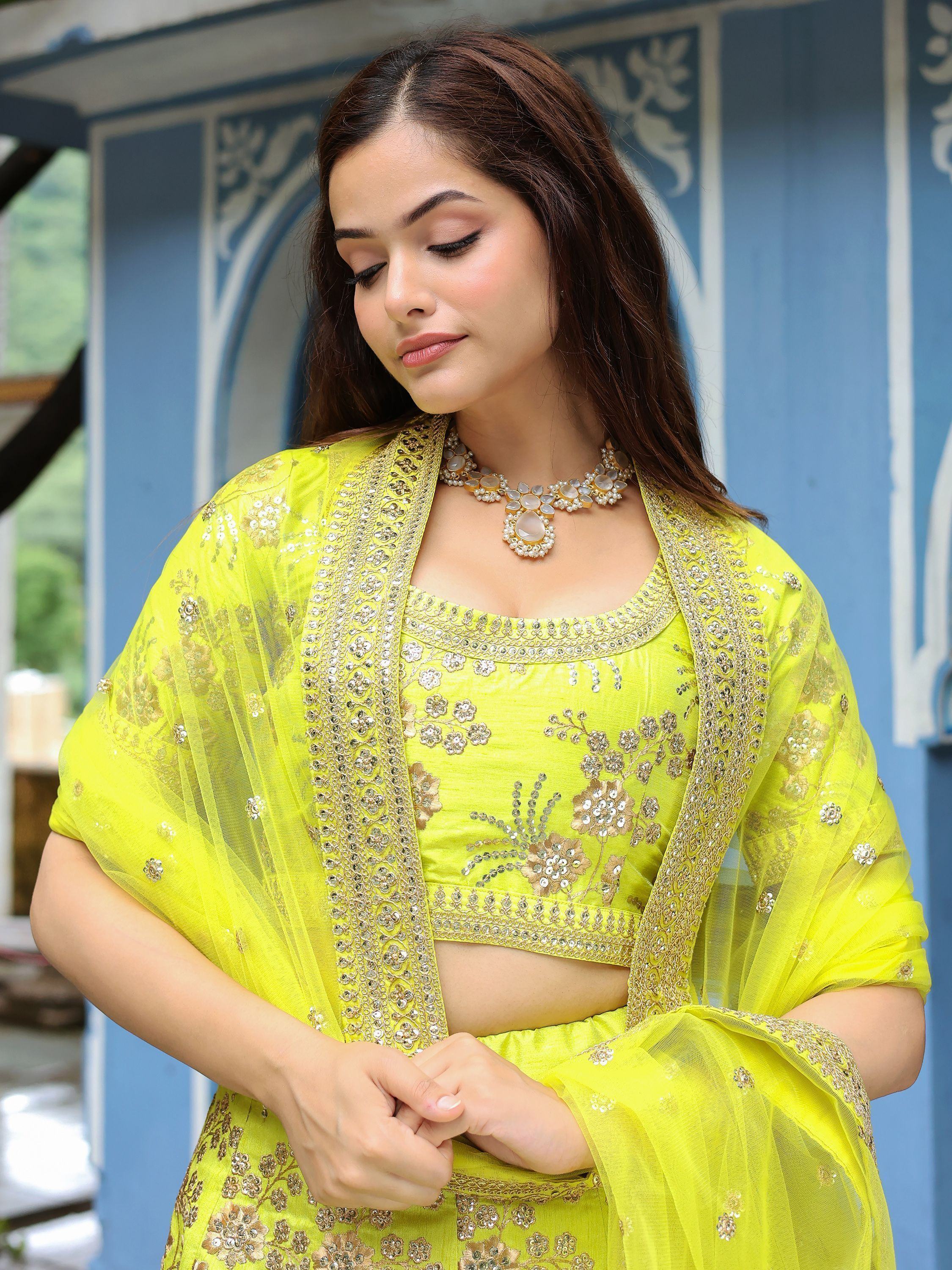 Vibrant yellow embroidered lehenga choli with sheer dupatta, perfect for Indian ethnic occasions