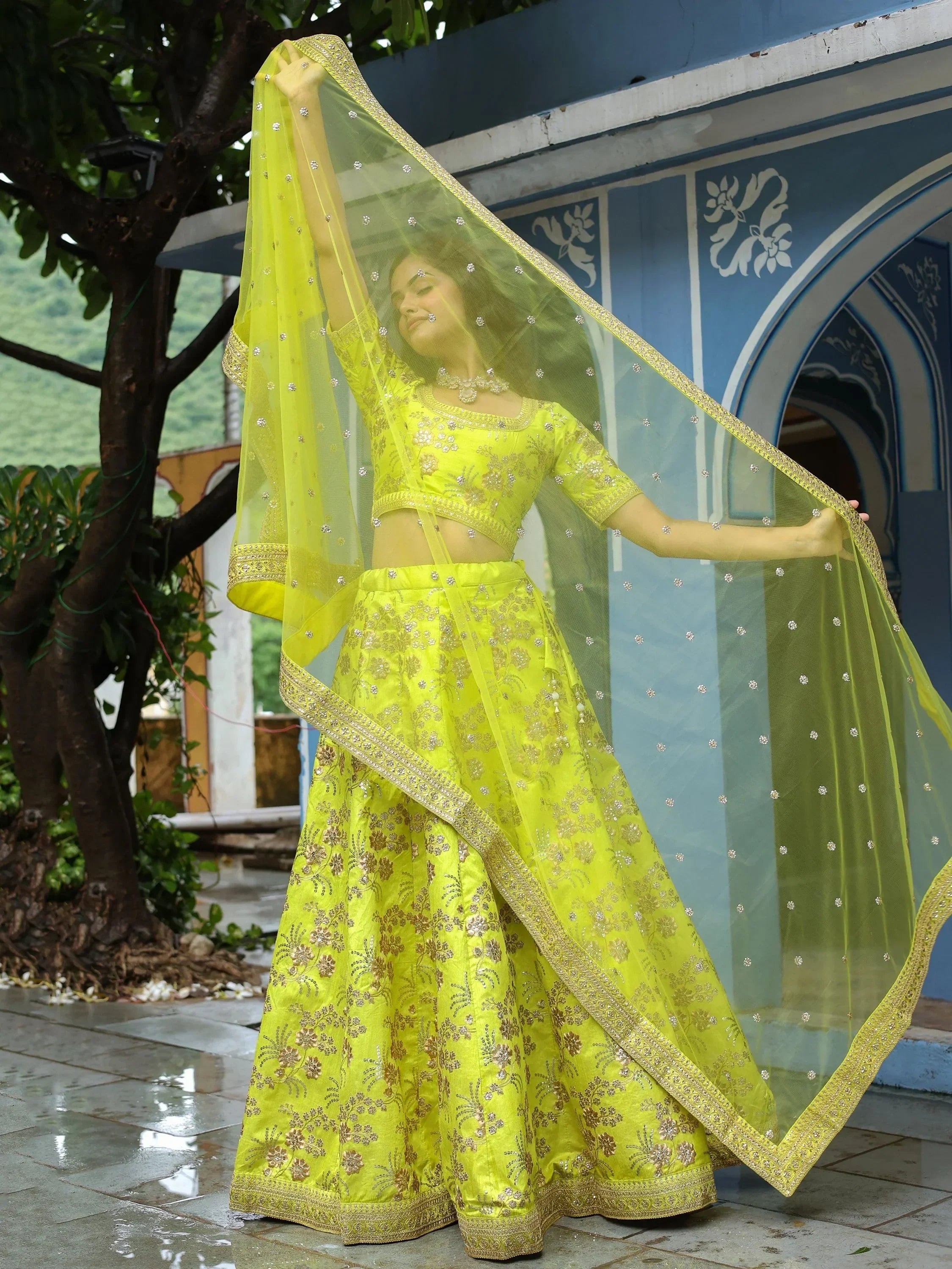 Lime green designer lehenga choli with gold embroidery and sheer dupatta, perfect for Indian ethnic occasions.