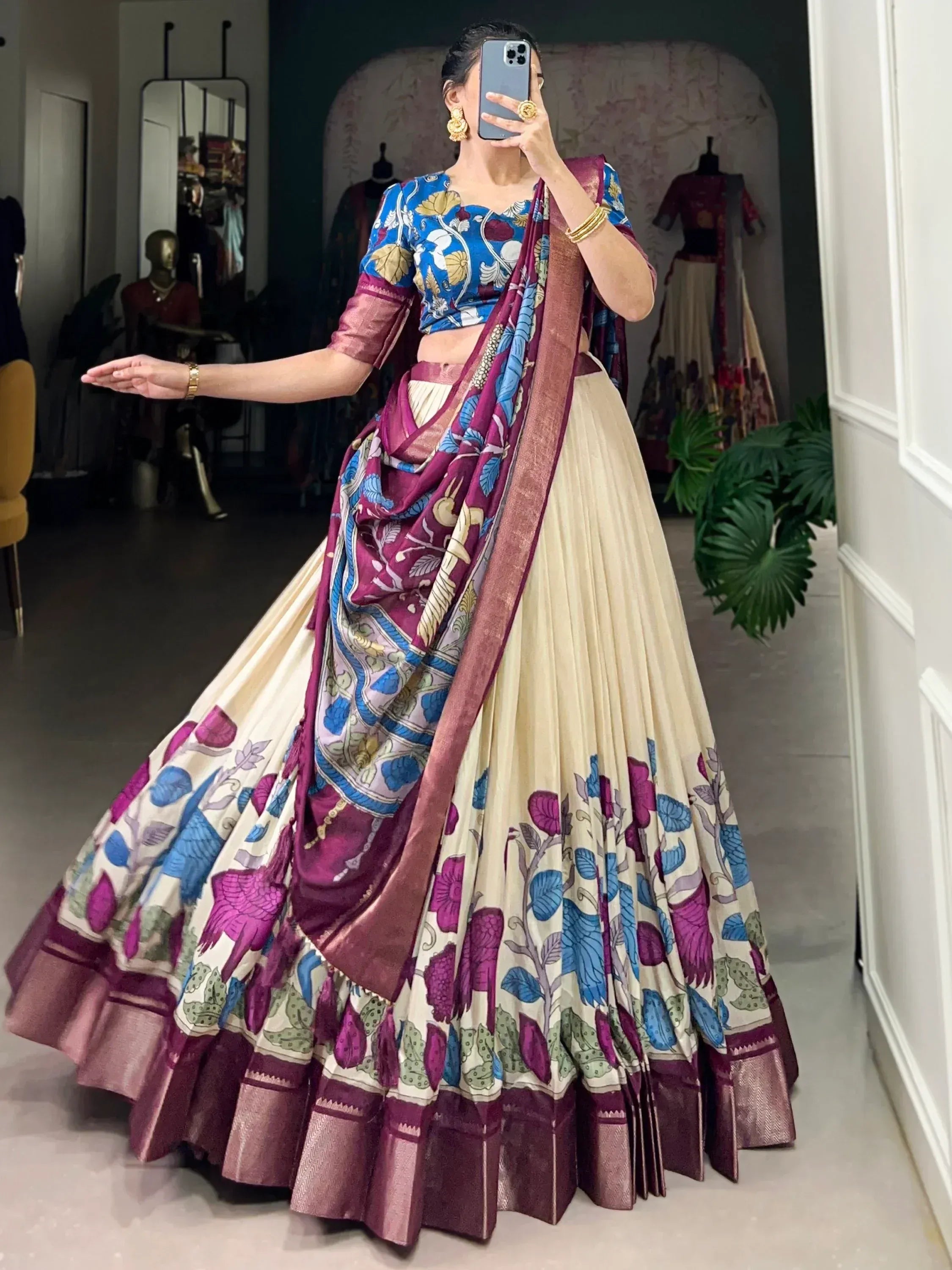 Woman in floral print lehenga choli with blue and maroon dupatta, ethnic Indian wear