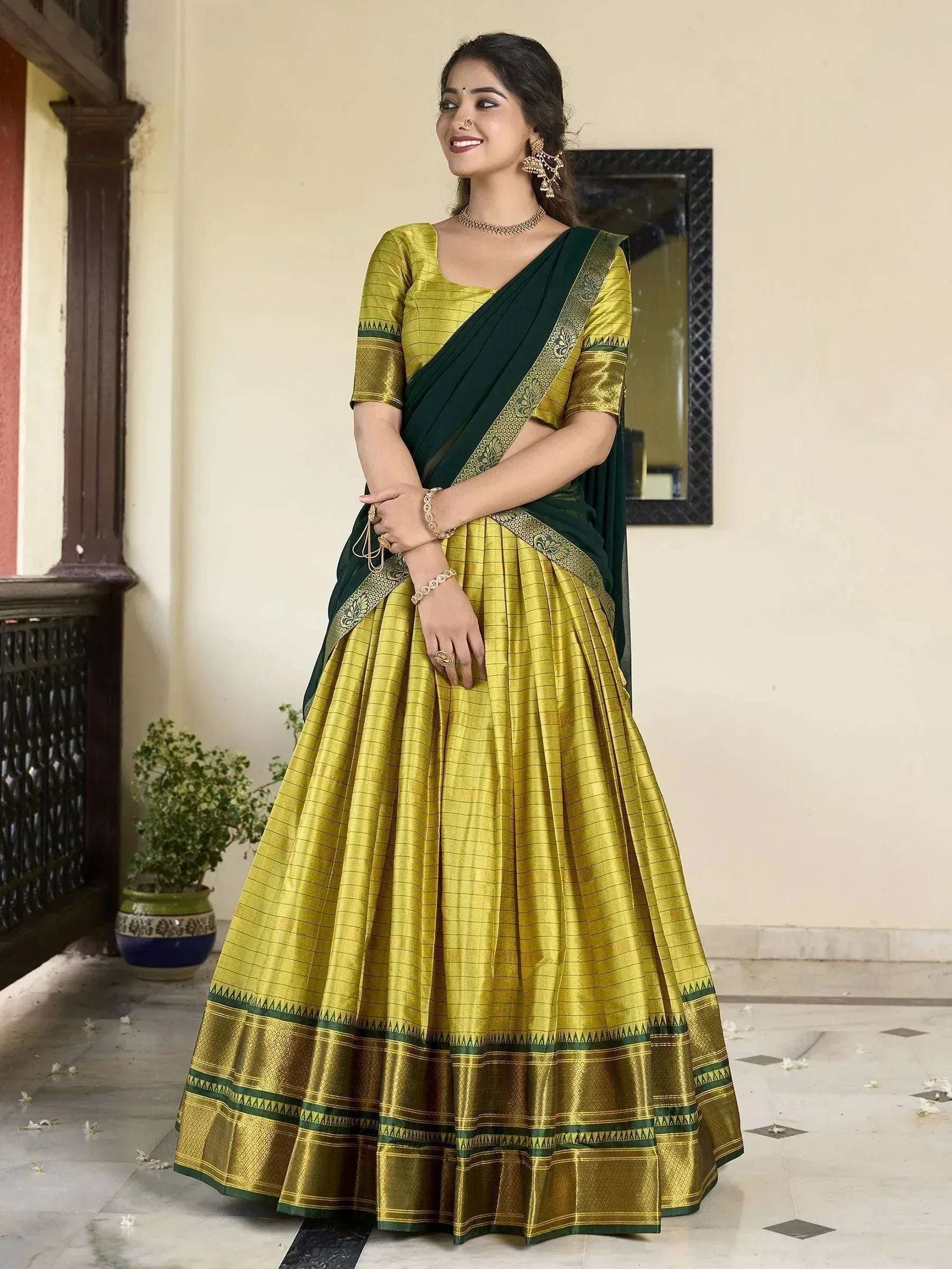 Elegant green and gold lehenga choli with embroidered border, perfect for Indian ethnic occasions