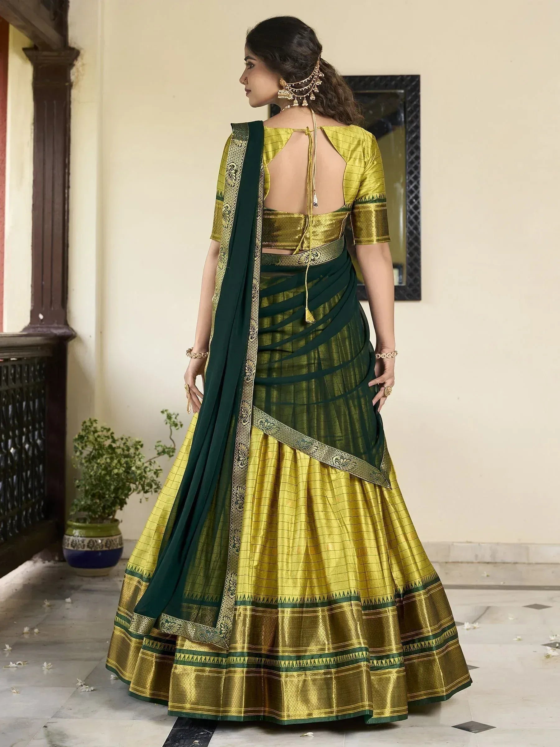 Green and gold designer lehenga choli with backless blouse and embroidered dupatta, perfect for Indian ethnic wear