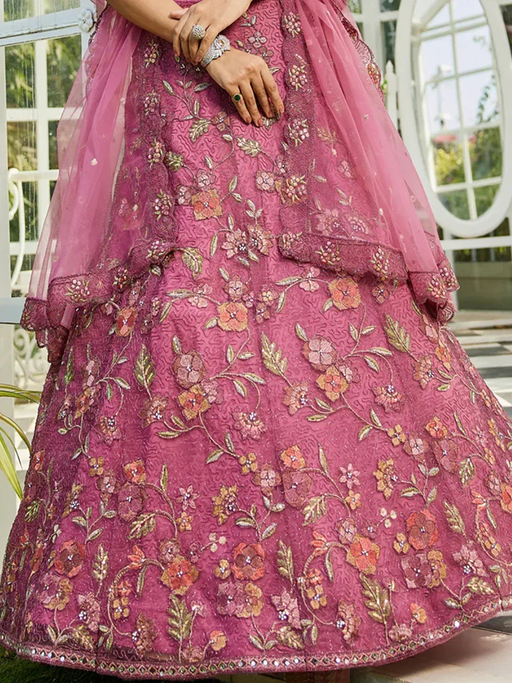 Pink floral embroidered lehenga choli with net dupatta, perfect for Indian weddings and festive occasions