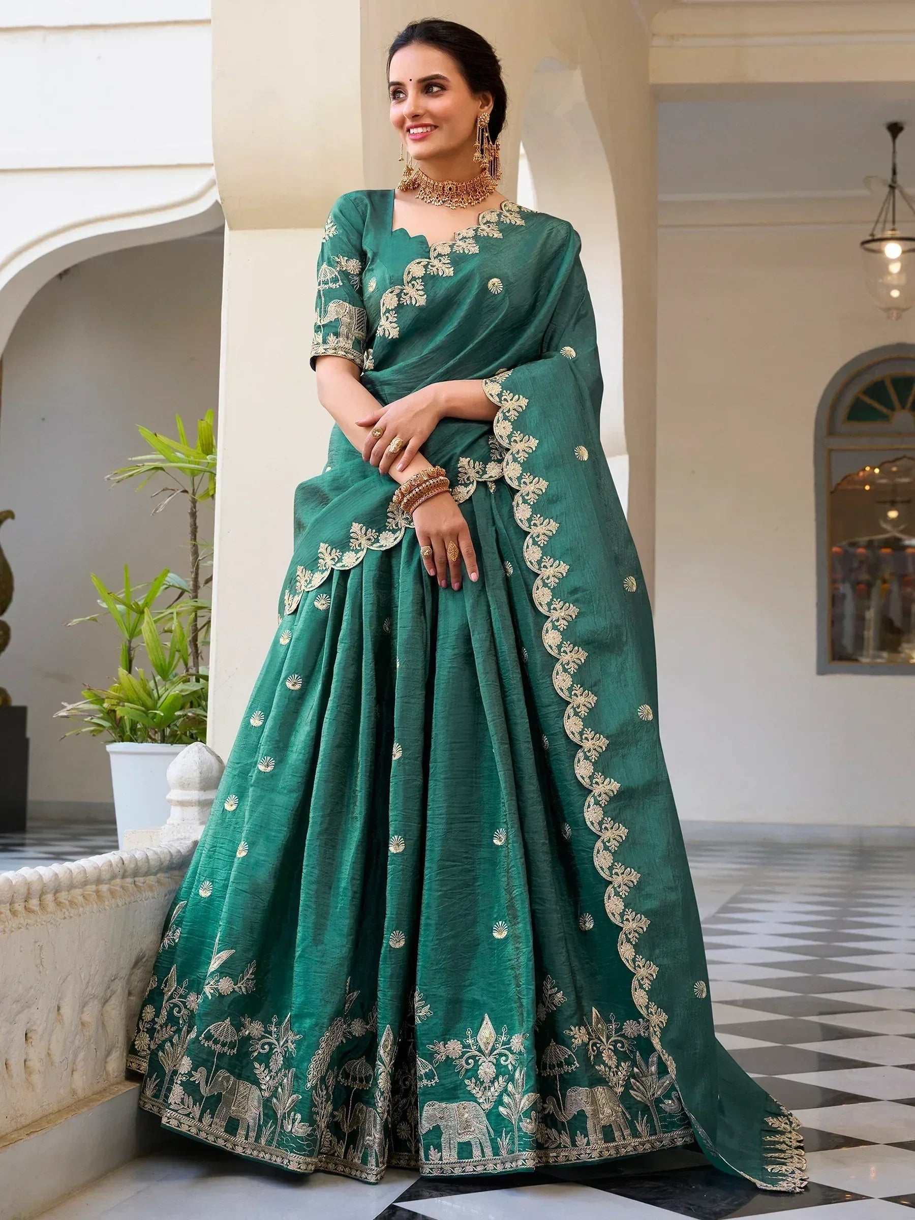 Emerald green designer lehenga choli with gold elephant embroidery, perfect for Indian ethnic wear occasions