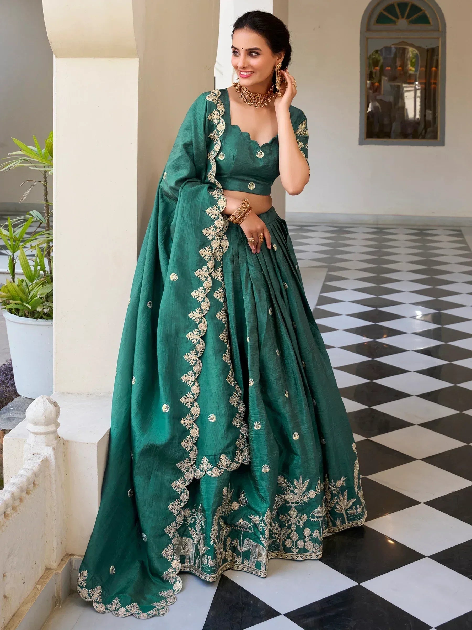 Emerald green designer lehenga choli with gold embroidery, perfect for Indian ethnic wear occasions.