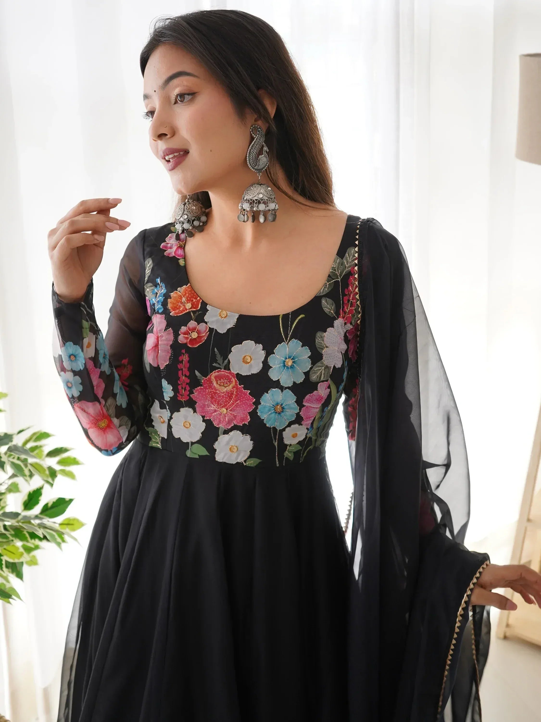 Black floral embroidered ethnic gown with sheer sleeves and jhumka earrings