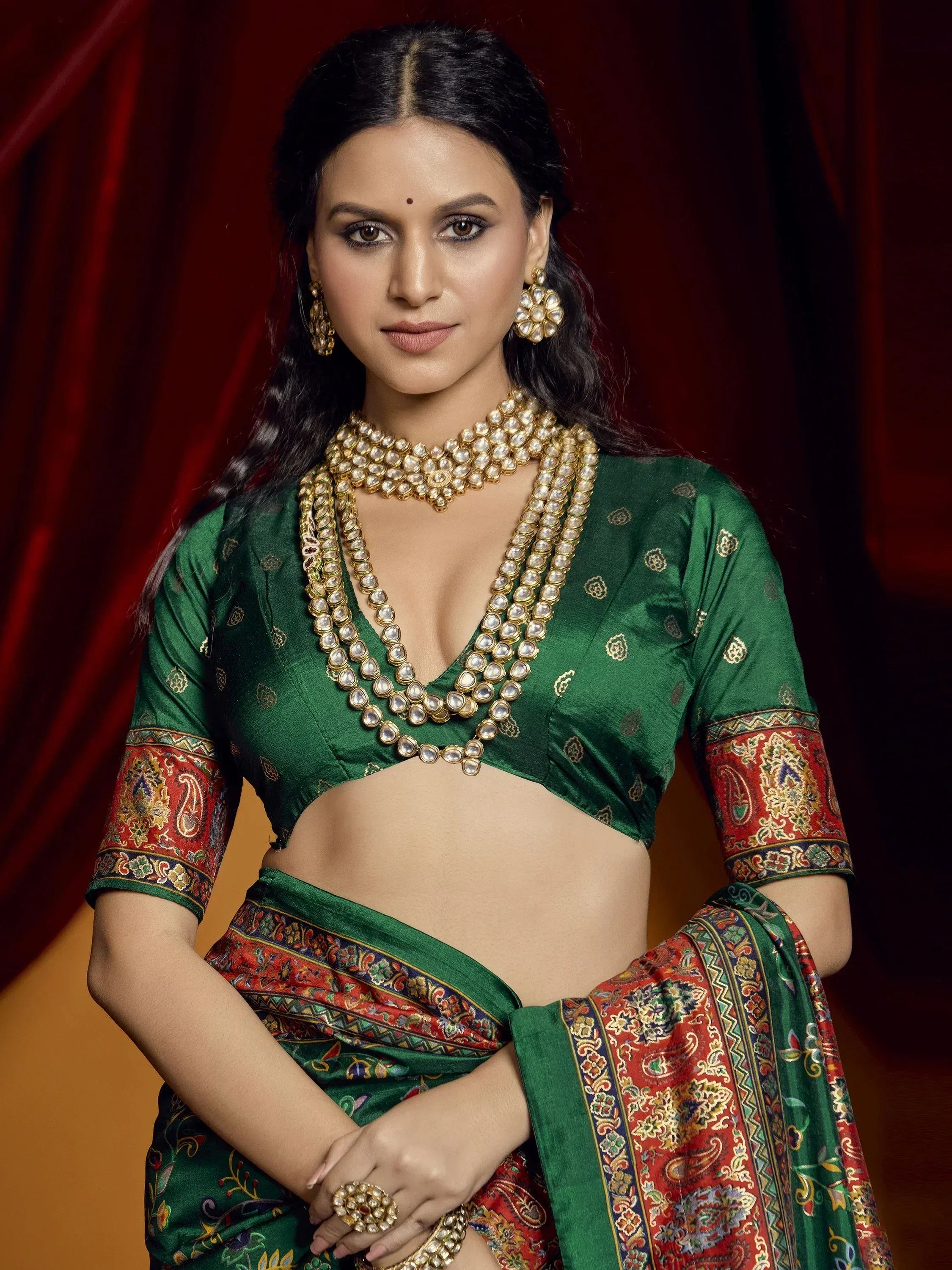 Green designer saree with red gold border, ethnic blouse, and pearl jewelry for Indian occasions