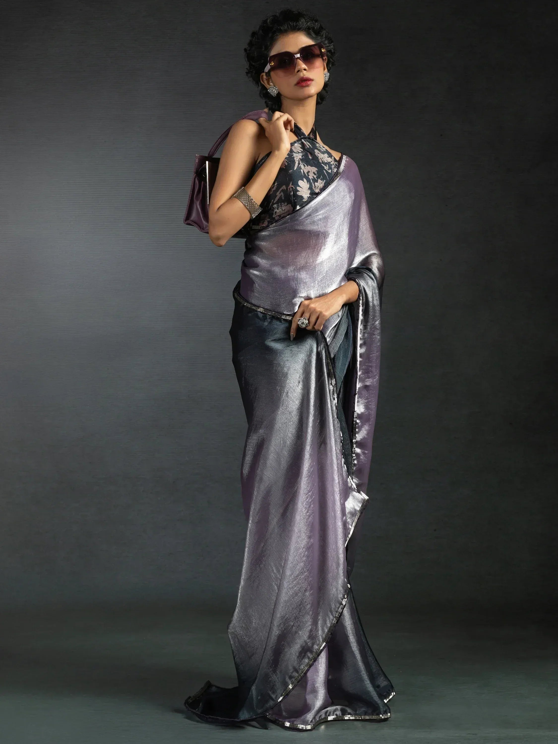 Stylish purple metallic saree with floral blouse, perfect for Indian ethnic wear occasions.
