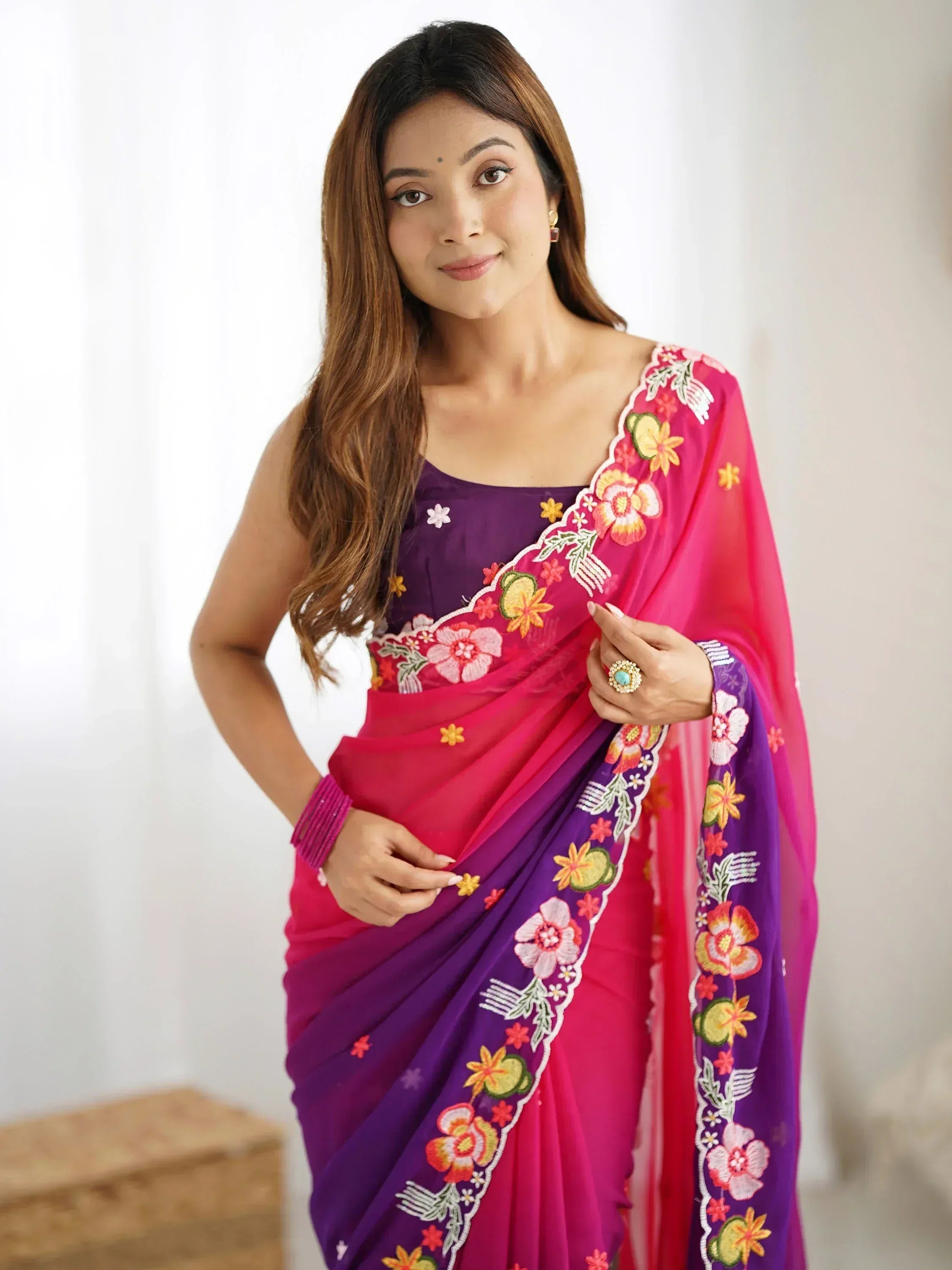 Vibrant pink and purple saree with floral embroidery, perfect for Indian ethnic wear occasions.